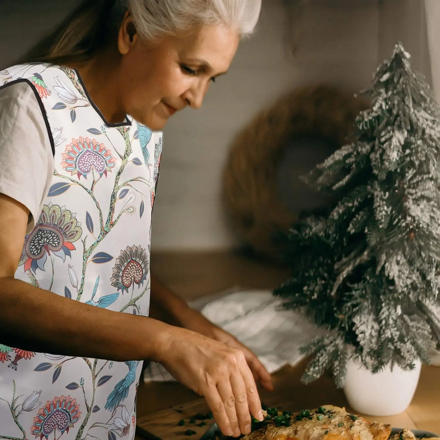 This waterproof adult bib dining apron provides clothing protection for seniors, elderly, and disabled patients during mealtimes and other messy activities.