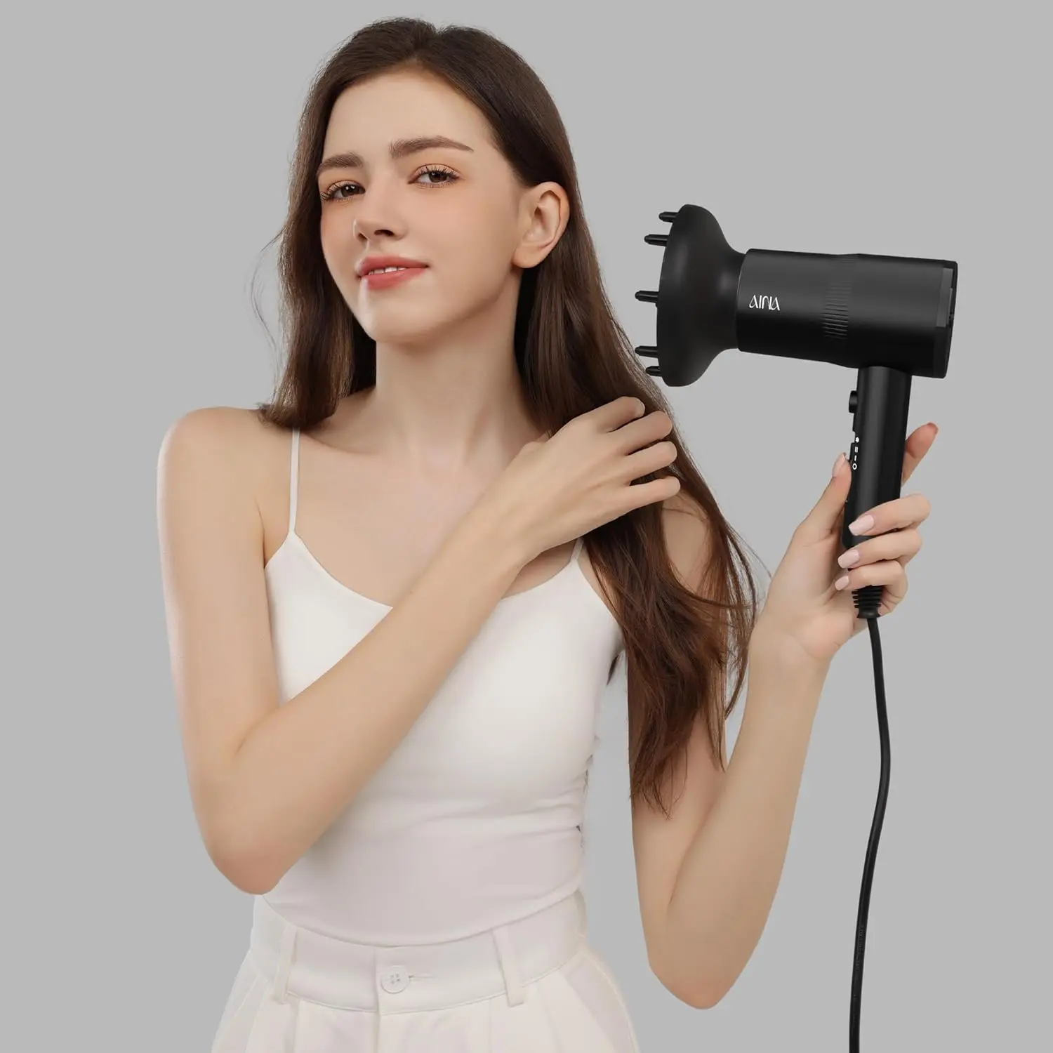 AINA hair dryer with diffuser attachment, featuring ionic and ceramic technology for fast drying and shiny, frizz-free hair.