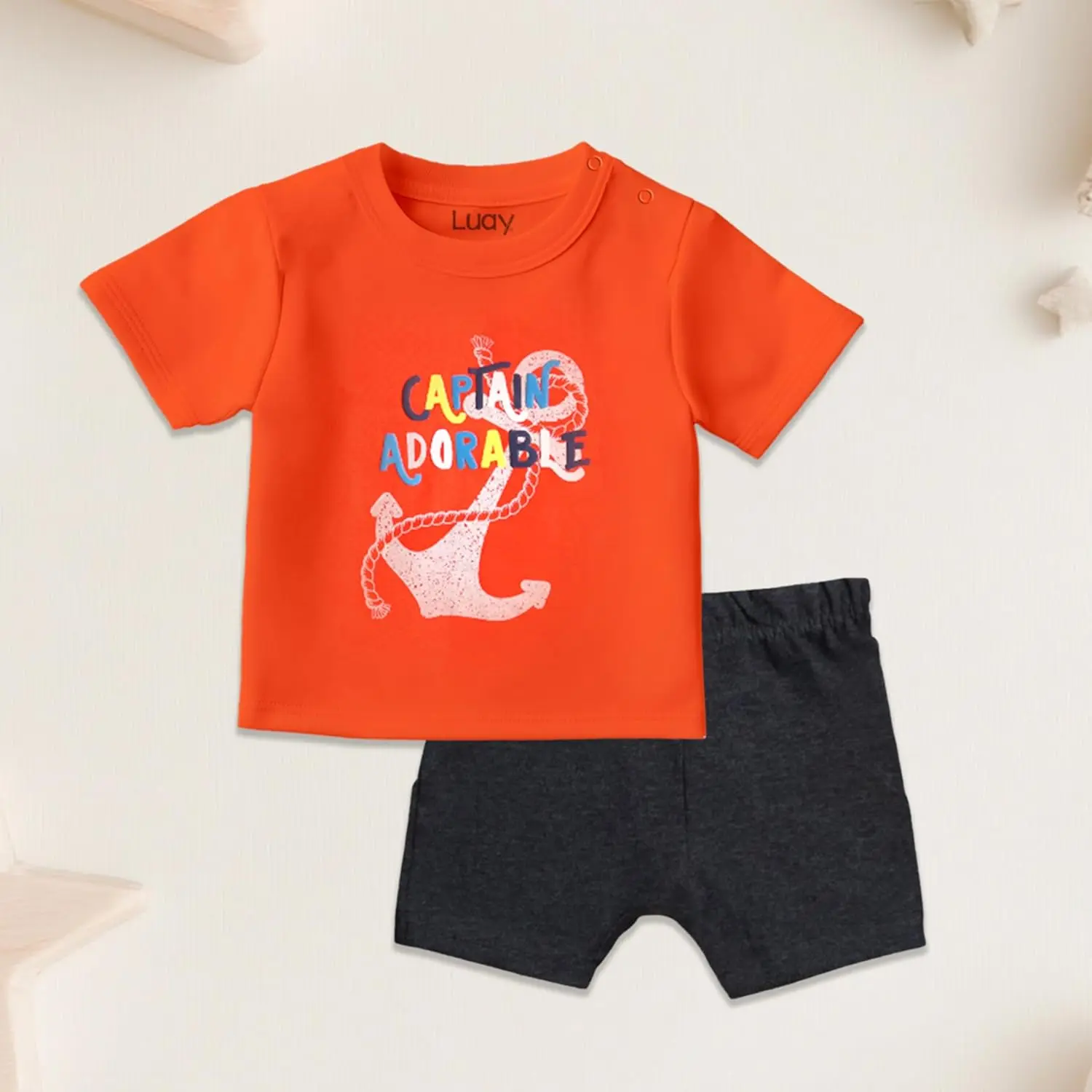 Adorable and practical LUAY baby clothes set featuring a playful design with colorful symbols on a soft, machine-washable cotton blend, perfect for gifting.