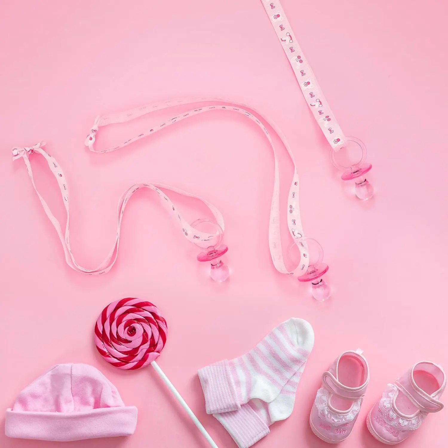 This set of 24 acrylic baby pacifier necklaces in pink and blue are perfect party favors and decorations for a gender reveal or baby shower.