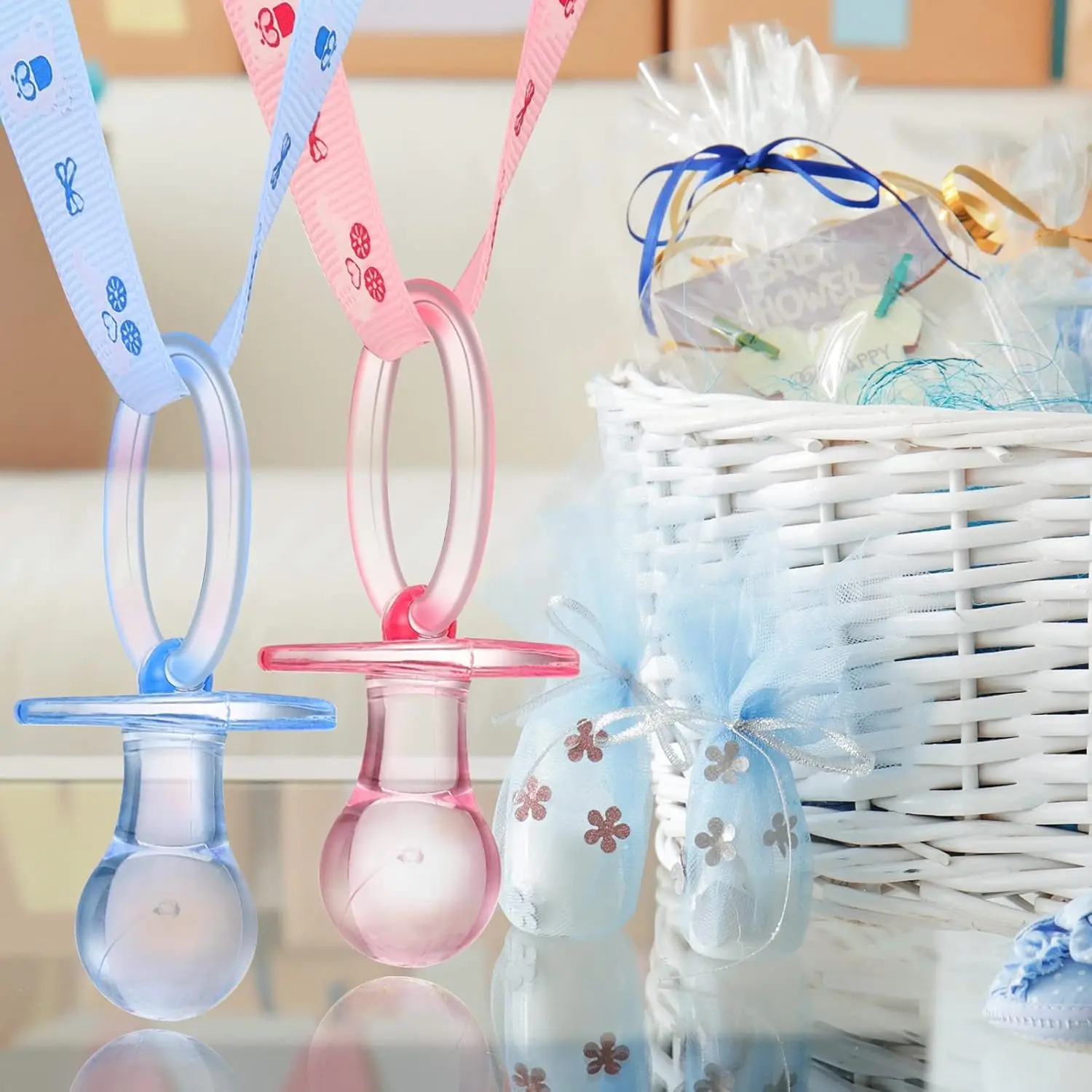 This set of 24 acrylic baby pacifier necklaces in pink and blue are perfect party favors and decorations for a gender reveal or baby shower.