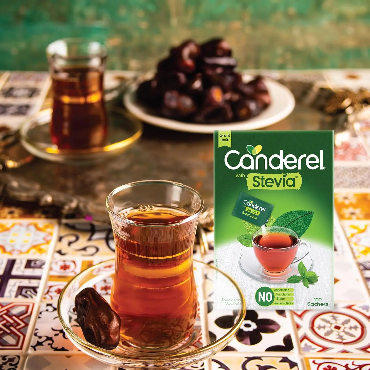 This image displays a pack of Canderel Stevia Sweetener Sachets, offering a sugar-free alternative for sweetening beverages like coffee and tea with zero calories and suitable for diabetics.