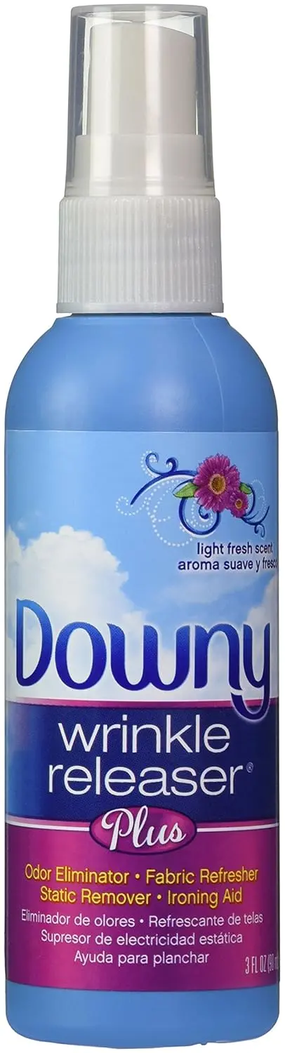 A travel-sized bottle of Downy Wrinkle Releaser with a light fresh scent, designed to quickly smooth wrinkles and eliminate odors from clothing, even on dry-clean-only fabrics.