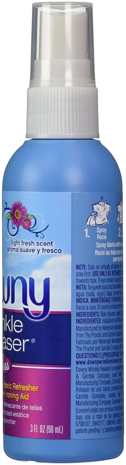 A travel-sized bottle of Downy Wrinkle Releaser with a light fresh scent, designed to quickly smooth wrinkles and eliminate odors from clothing, even on dry-clean-only fabrics.