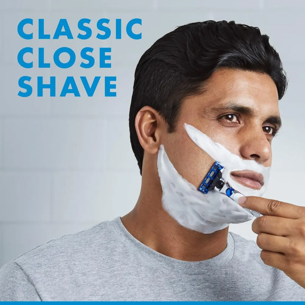 Gillette Mach3 Turbo refillable razor with handle and six blade refills, featuring three sharp blades, 3D ball for contouring, enhanced lubrastrip, and microfins for a close, comfortable shave.