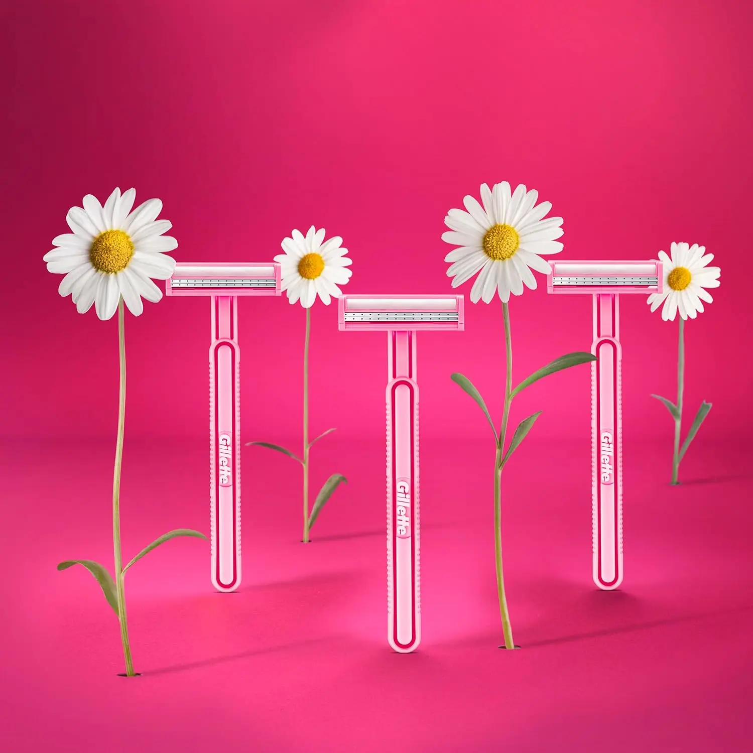 This image shows a pack of 18 Gillette Venus Daisy disposable razors featuring 2 thin blades for comfort, a lubricating strip for a smooth shave, a fixed head, and a comfortable grip handle designed for secure hair removal.