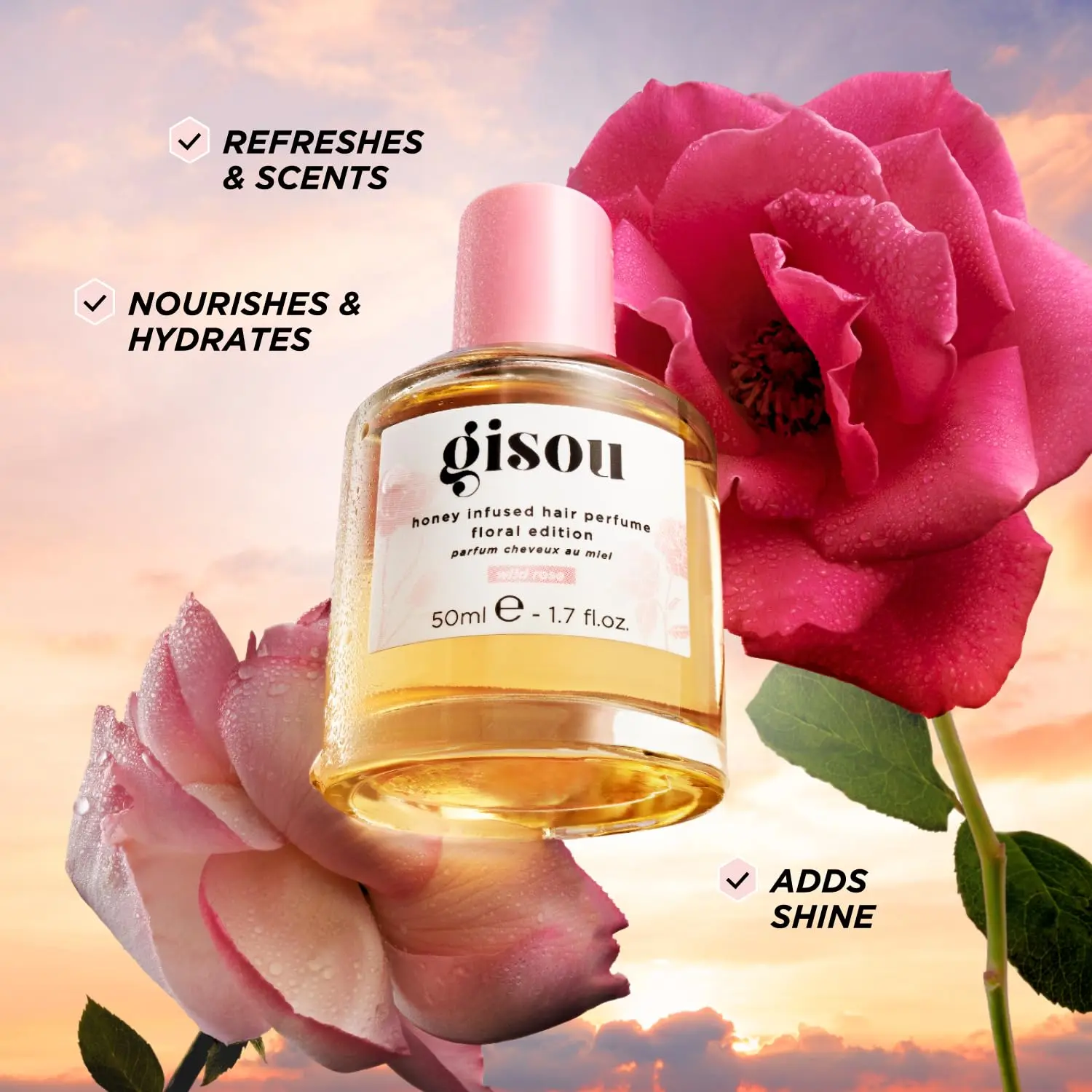A small bottle of Gisou Honey Infused Hair Perfume in Wild Rose scent, designed to refresh and delicately scent hair with argan oil.