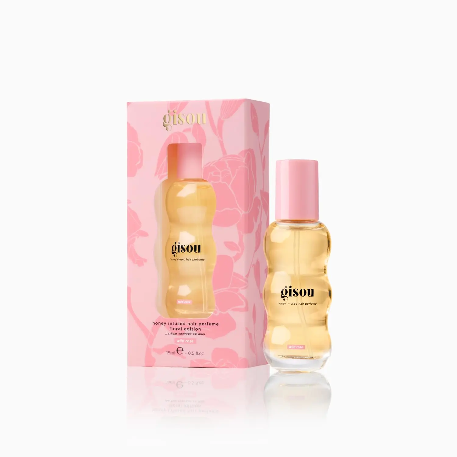 A small bottle of Gisou Honey Infused Hair Perfume in Wild Rose scent, designed to refresh and delicately scent hair with argan oil.