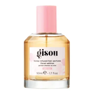 A bottle of GISOU Wild Rose Hair Perfume infused with honey, offering UV protection and a refreshing, garden-inspired fragrance.