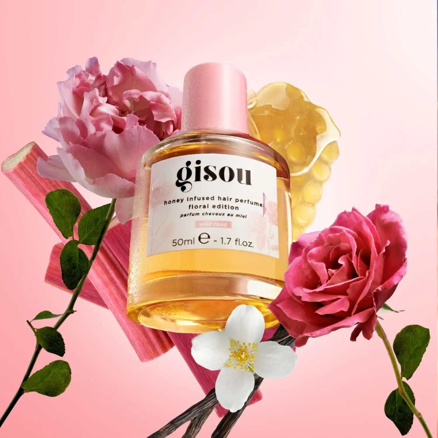 A bottle of GISOU Wild Rose Hair Perfume infused with honey, offering UV protection and a refreshing, garden-inspired fragrance.