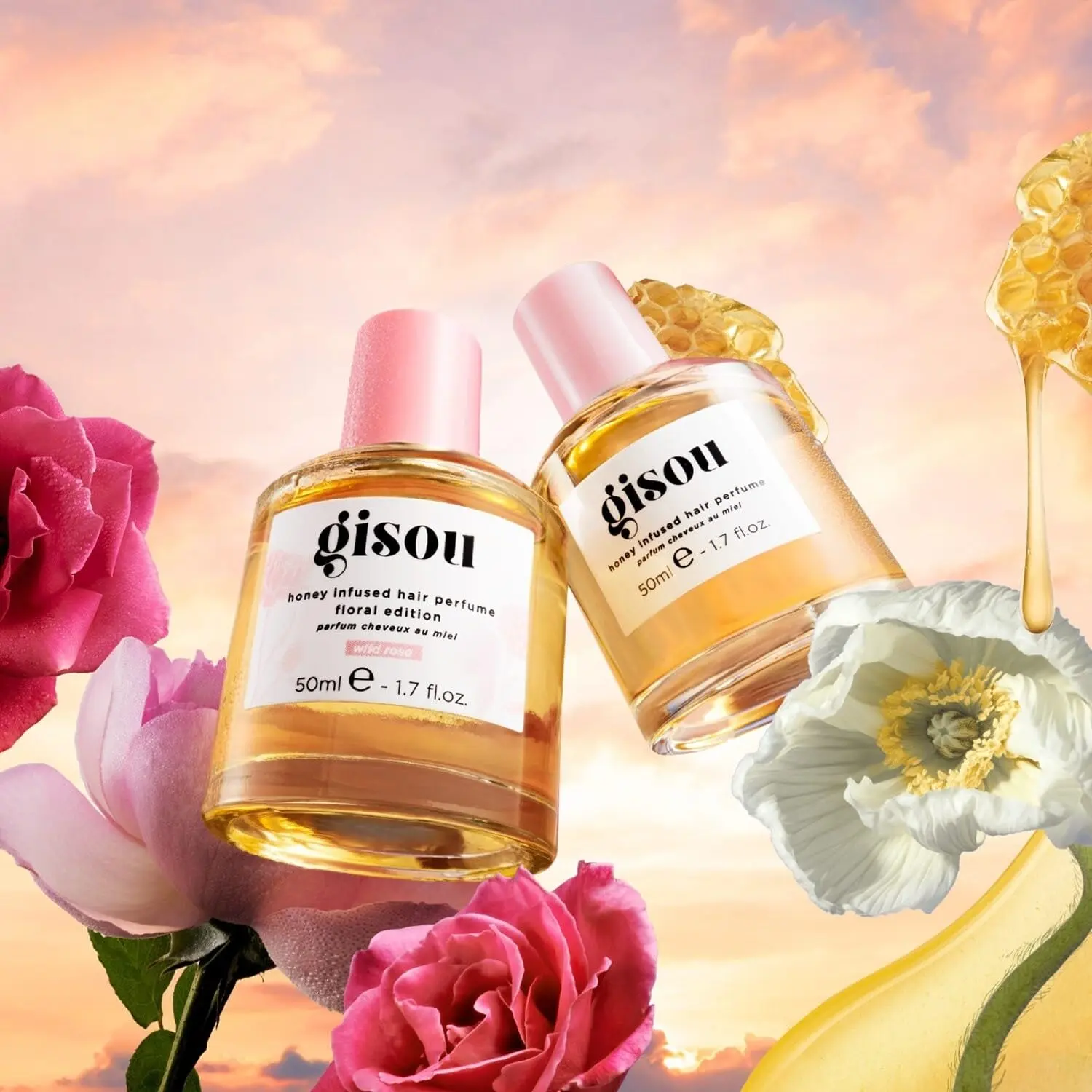 A bottle of GISOU Wild Rose Hair Perfume infused with honey, offering UV protection and a refreshing, garden-inspired fragrance.