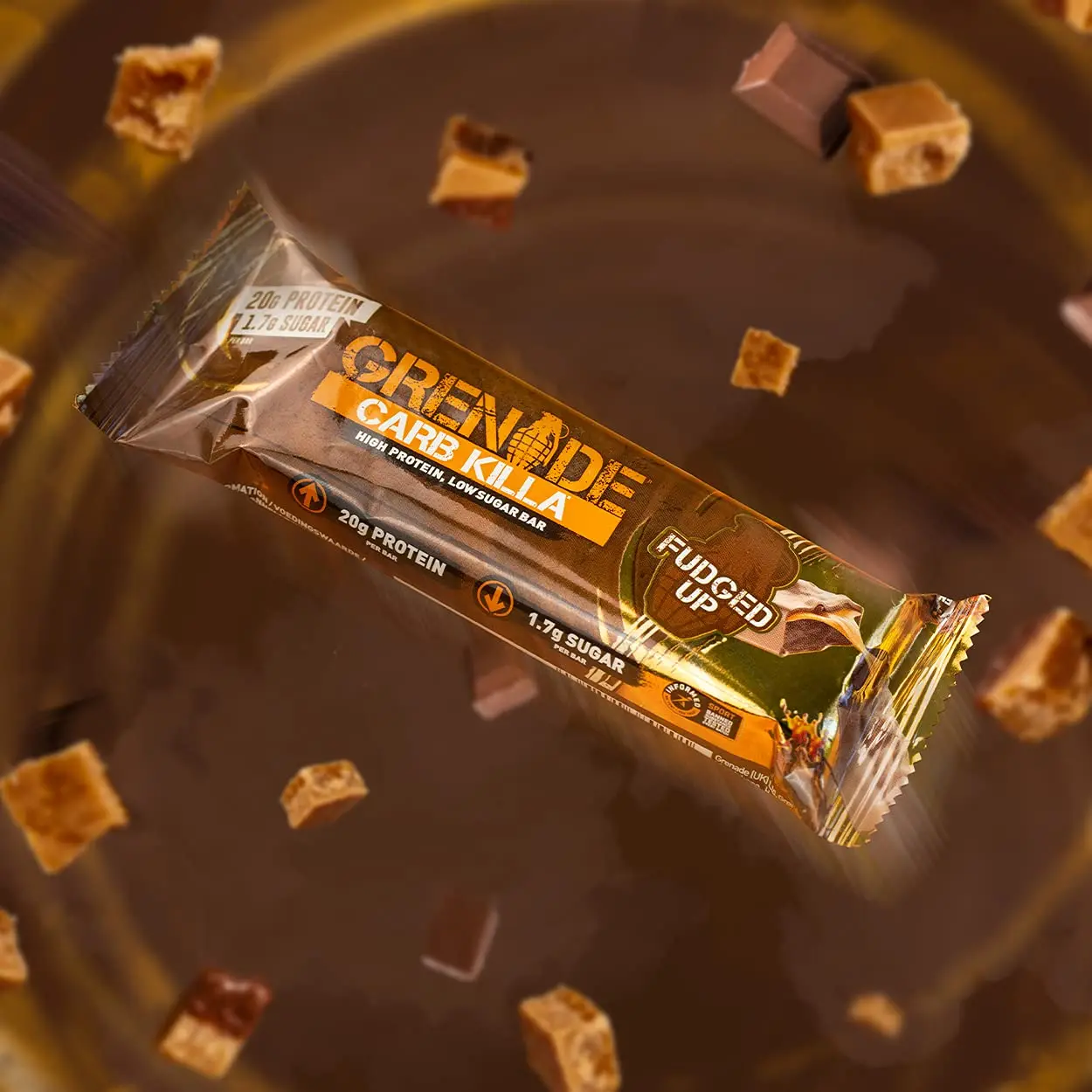 A pack of Grenade Carb Killa Fudged Up protein bars, a low sugar snack with a soft fudge center, caramel layer, and milk chocolate coating, providing 20g of protein per bar.