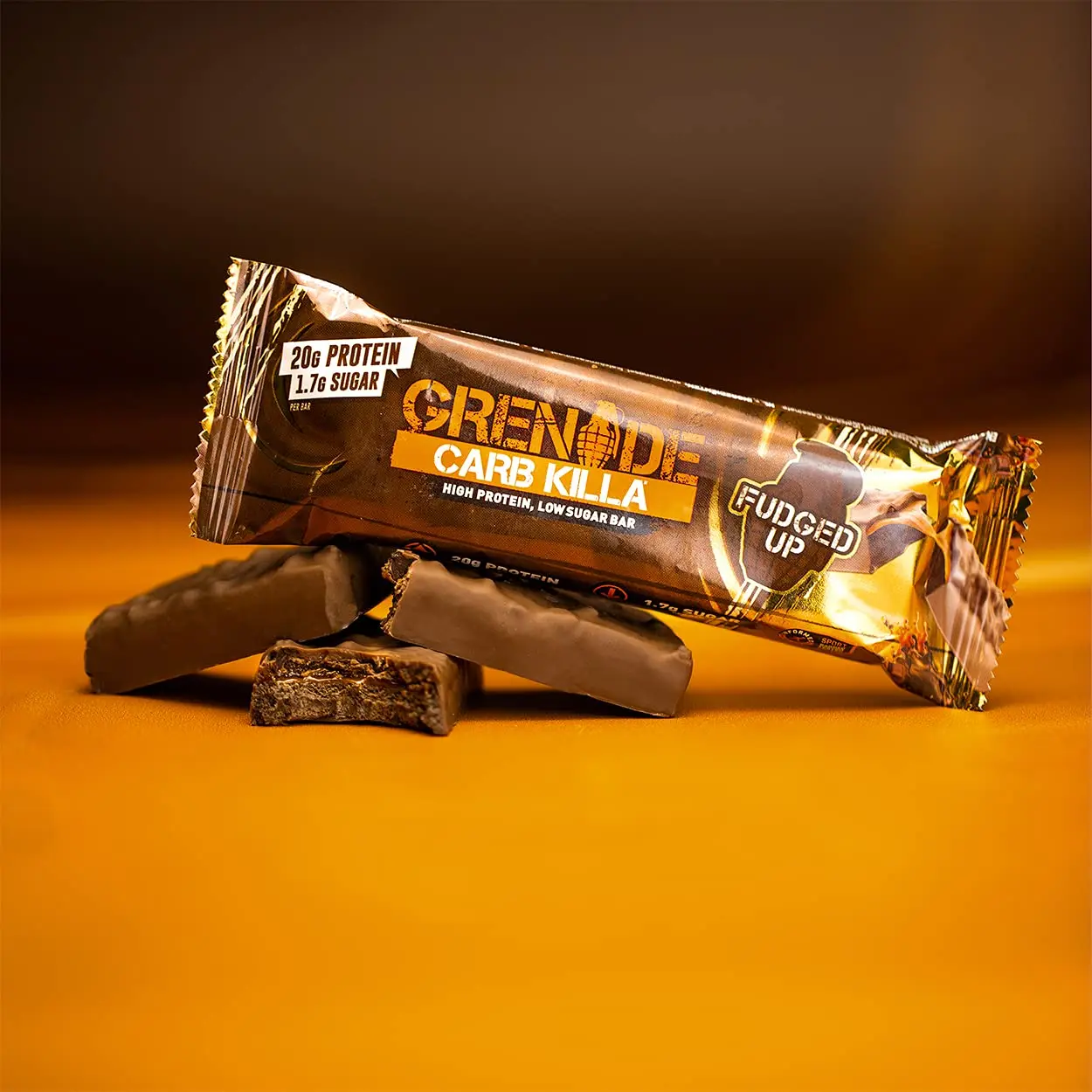 A pack of Grenade Carb Killa Fudged Up protein bars, a low sugar snack with a soft fudge center, caramel layer, and milk chocolate coating, providing 20g of protein per bar.