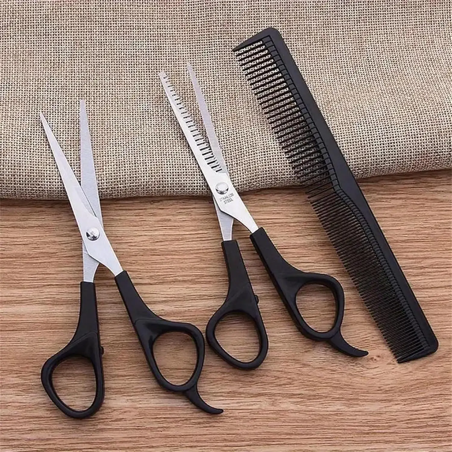 This three-piece stainless steel hair cutting set includes shears, thinning scissors, and a comb for professional or home use on men, women, and pets.