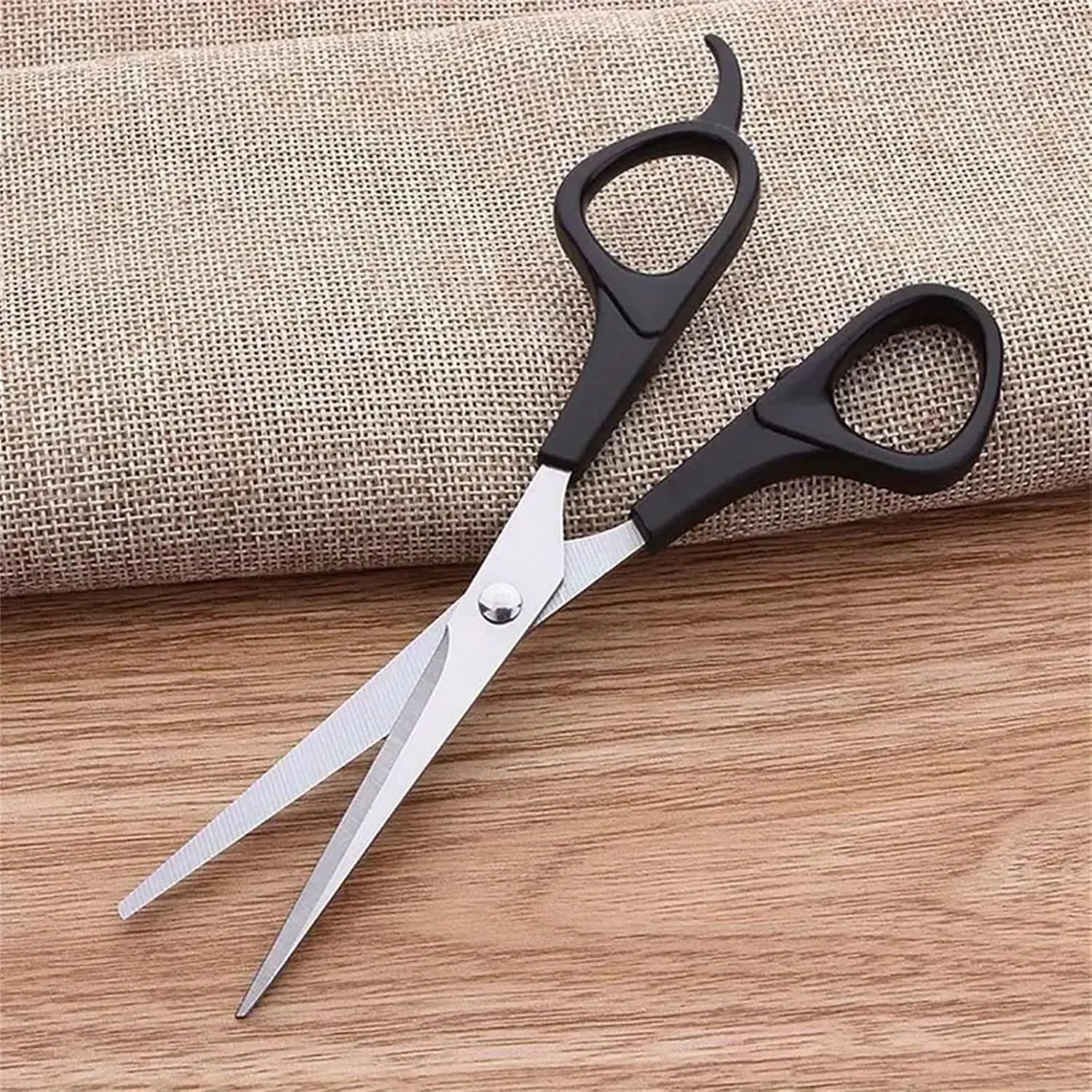 This three-piece stainless steel hair cutting set includes shears, thinning scissors, and a comb for professional or home use on men, women, and pets.