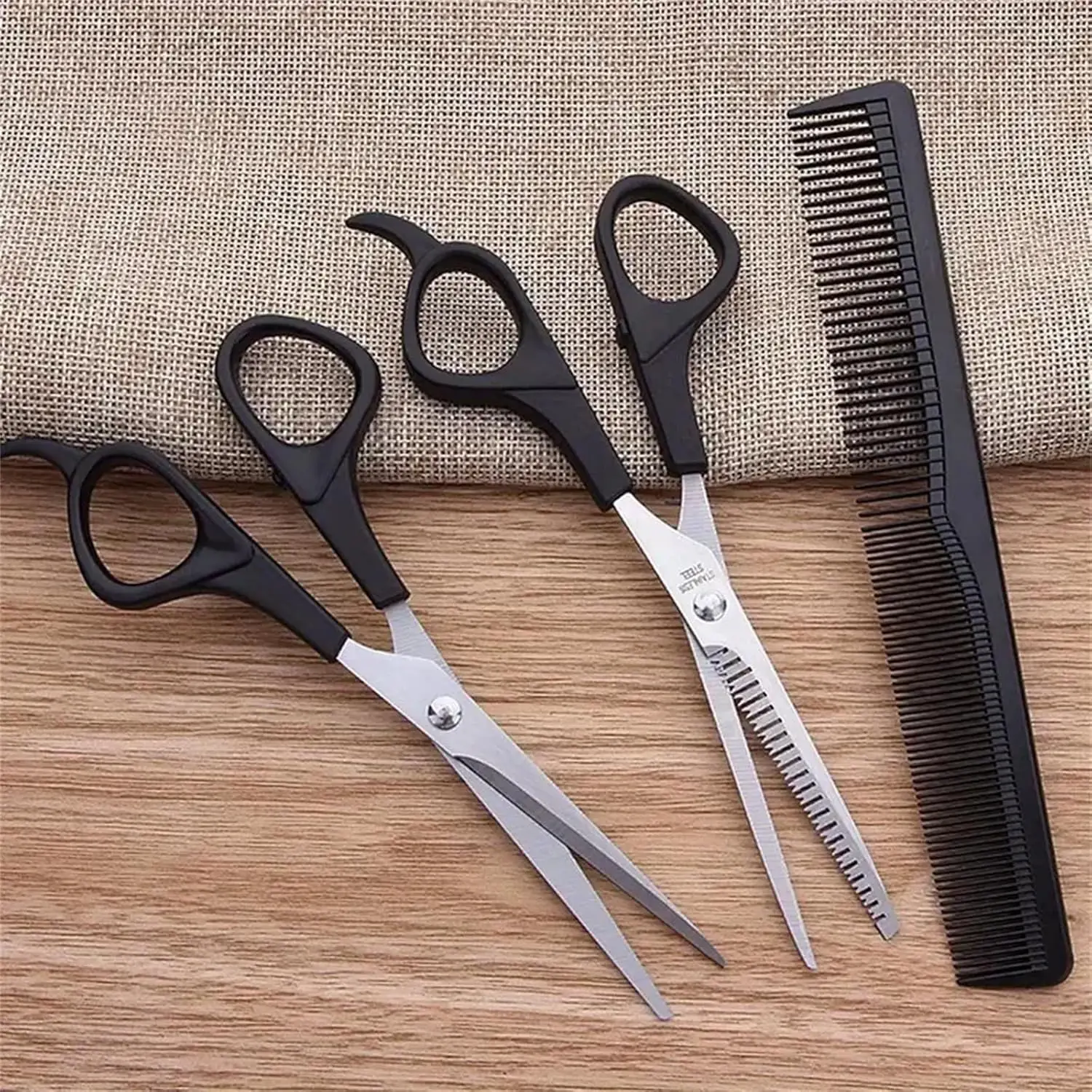 This three-piece stainless steel hair cutting set includes shears, thinning scissors, and a comb for professional or home use on men, women, and pets.