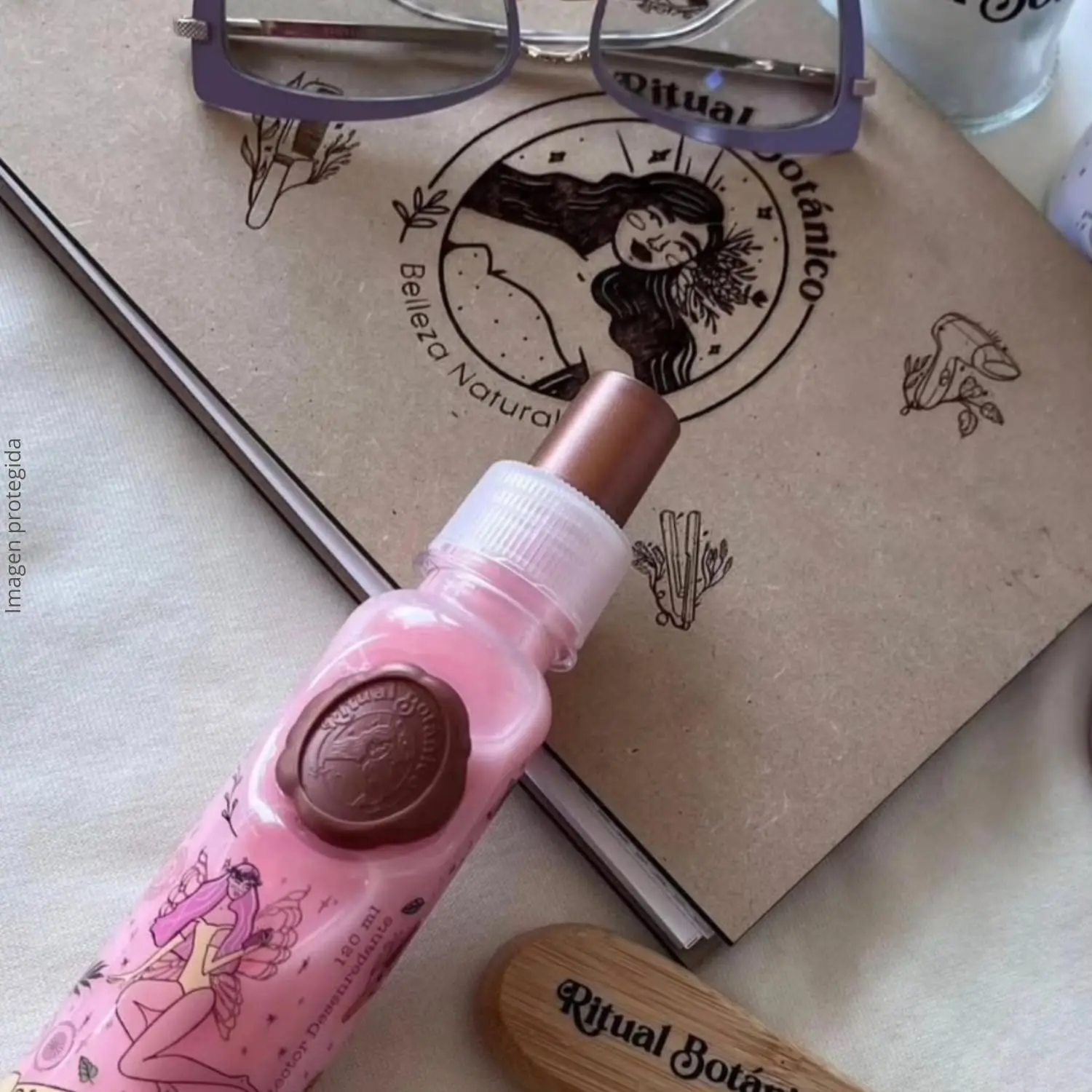 Duo of hair perfume and heat protectant sprays with floral and fruity scents that detangle, control frizz, and provide sun protection for healthy, manageable hair.