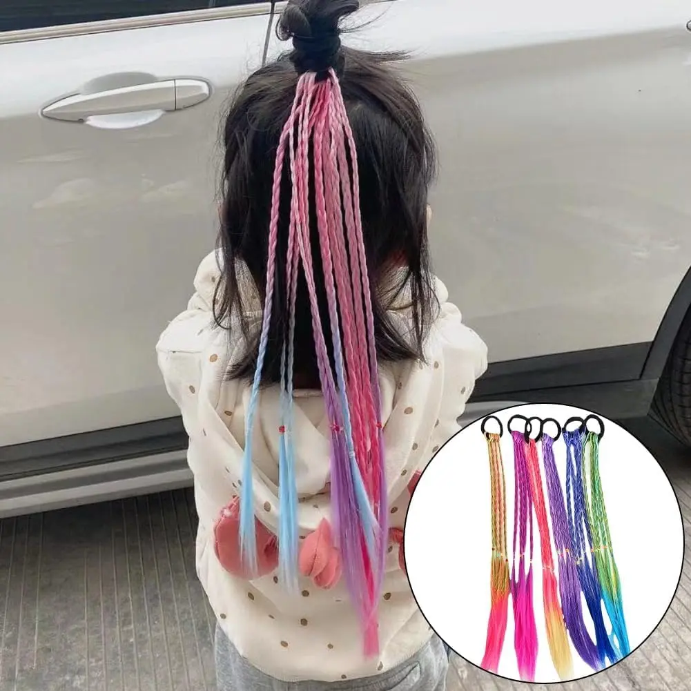 Six colorful rainbow hair extensions are attached to a young girl's hair, adding vibrant braids for a fun and playful look perfect for parties, cosplay, and everyday styling.