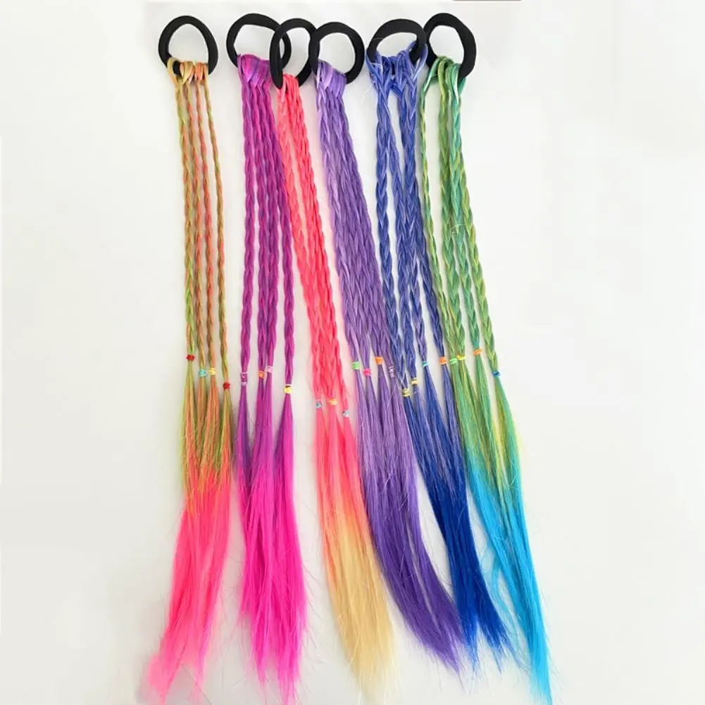 Six colorful rainbow hair extensions are attached to a young girl's hair, adding vibrant braids for a fun and playful look perfect for parties, cosplay, and everyday styling.
