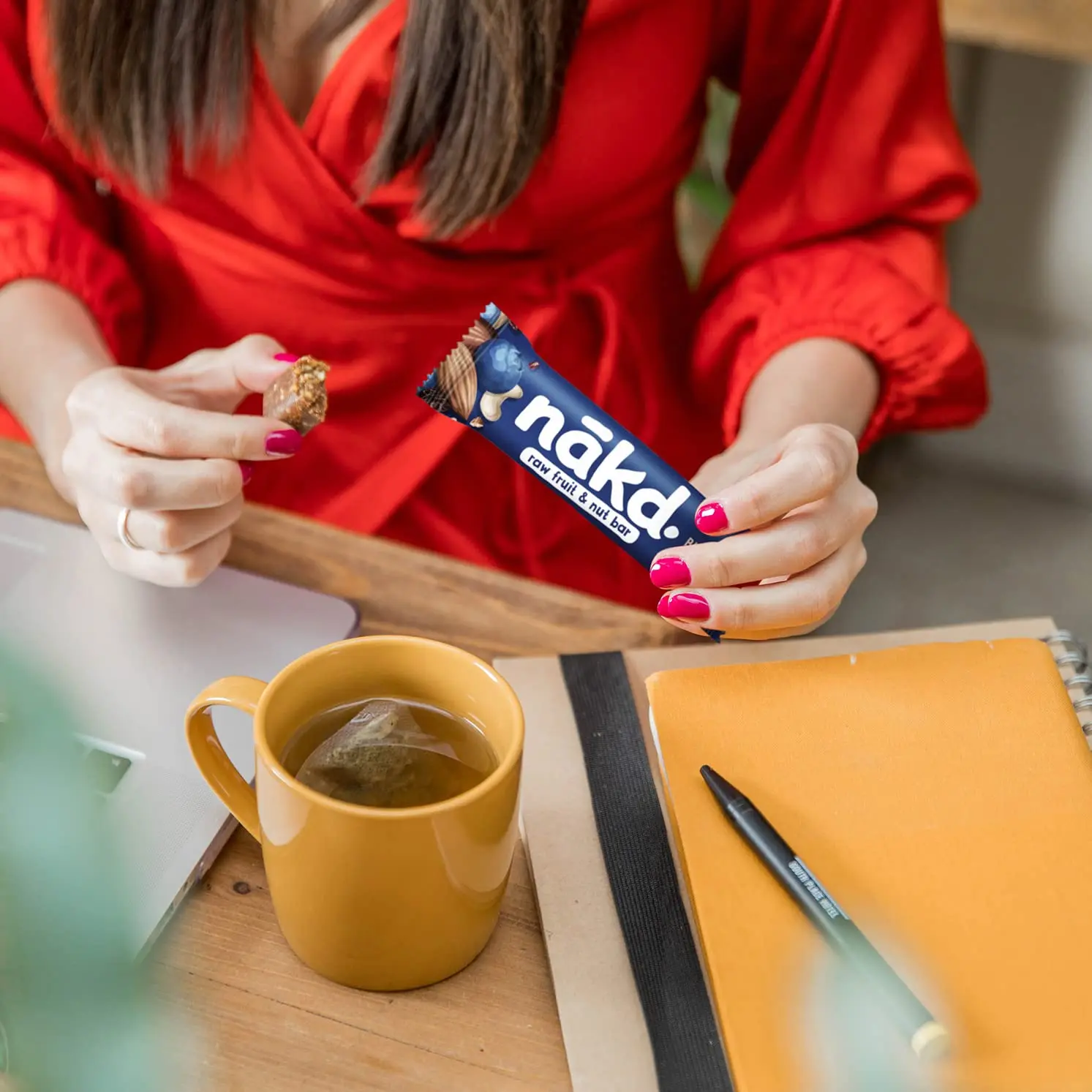 Individually wrapped NAKD Blueberry Muffin raw fruit and nut bars, a gluten-free, vegan, and kosher snack made with 100% natural ingredients and no added sugar.