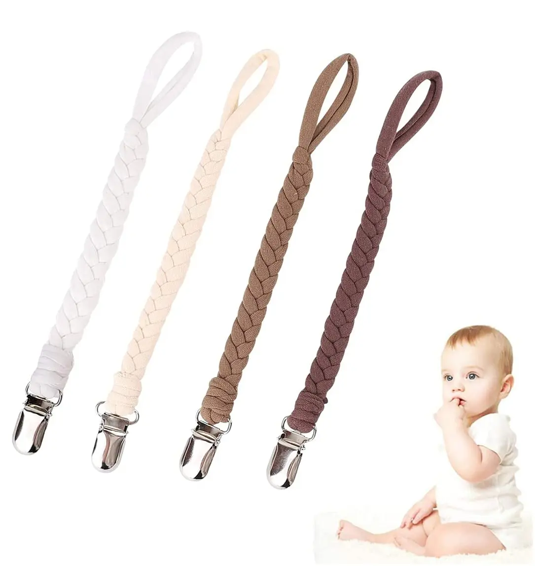 Four colorful pacifier clips securely attached to baby clothes, keeping pacifiers clean and within reach for boys and girls.