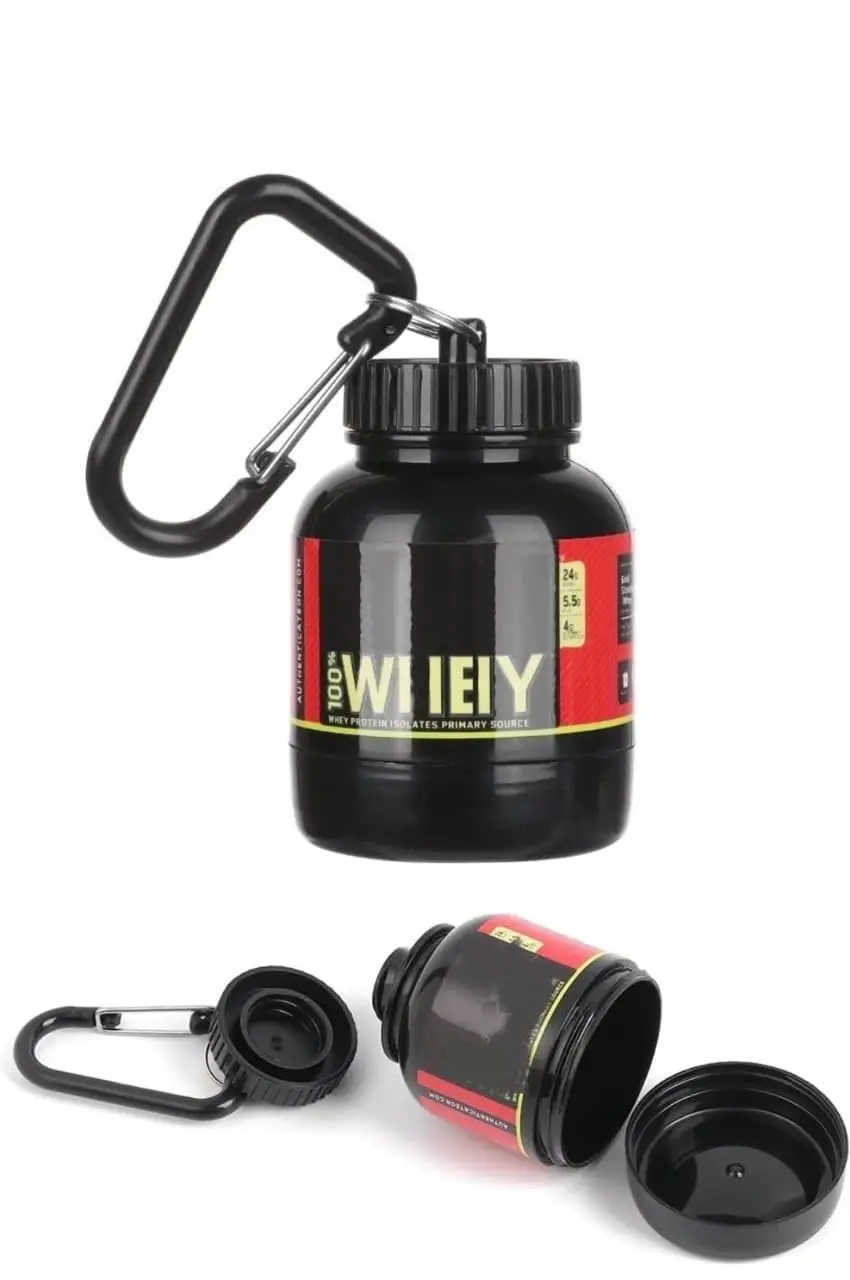 This black, portable protein powder container with a keychain and funnel is perfect for carrying pre-workout supplements to the gym or while traveling for fitness.
