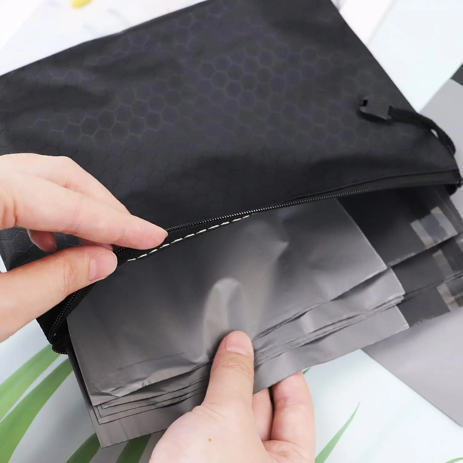 This pack contains 200 gray, opaque sanitary disposal bags with a tape seal for discreet and leak-proof disposal of feminine hygiene products like pads and tampons, along with two storage bags for portability.