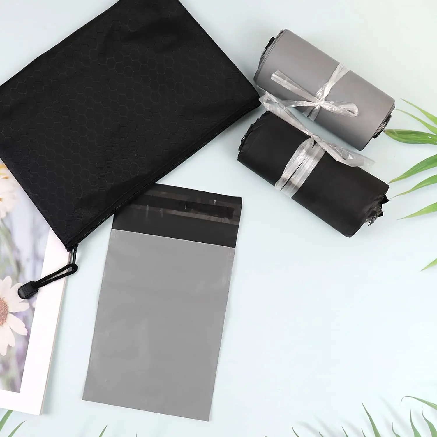 This pack contains 200 gray, opaque sanitary disposal bags with a tape seal for discreet and leak-proof disposal of feminine hygiene products like pads and tampons, along with two storage bags for portability.