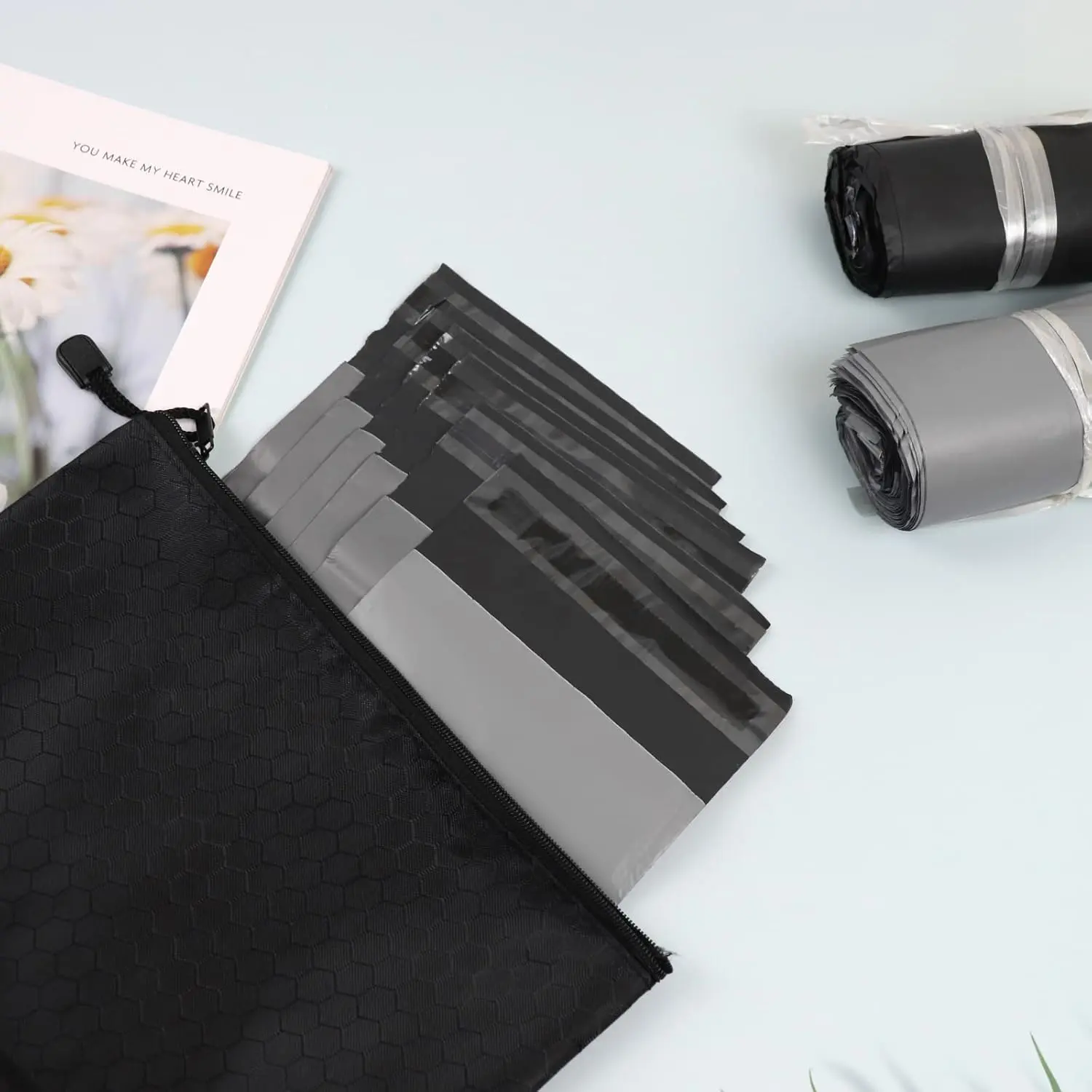 This pack contains 200 gray, opaque sanitary disposal bags with a tape seal for discreet and leak-proof disposal of feminine hygiene products like pads and tampons, along with two storage bags for portability.