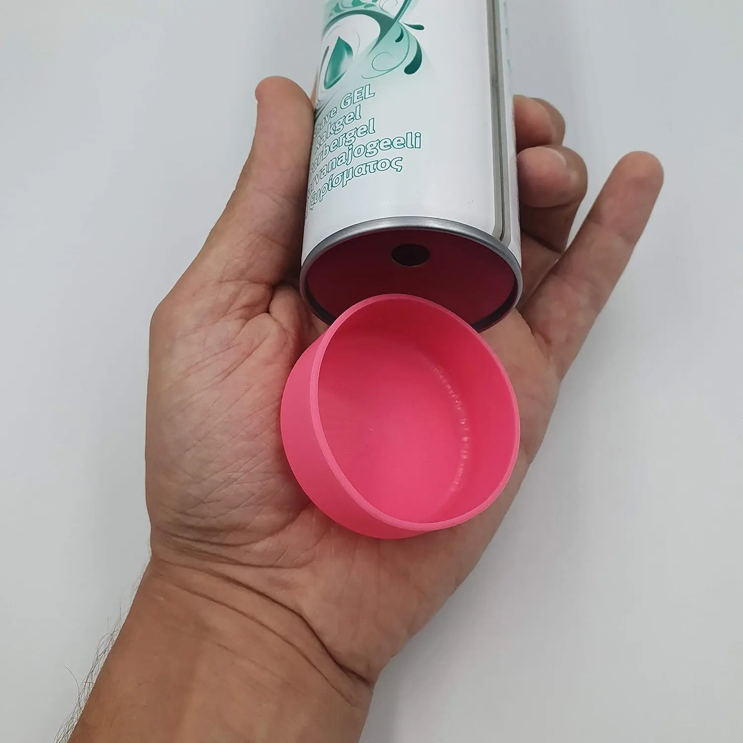 Pink silicone shaving cream can cover prevents rust rings and protects bathroom surfaces from stains and damage.