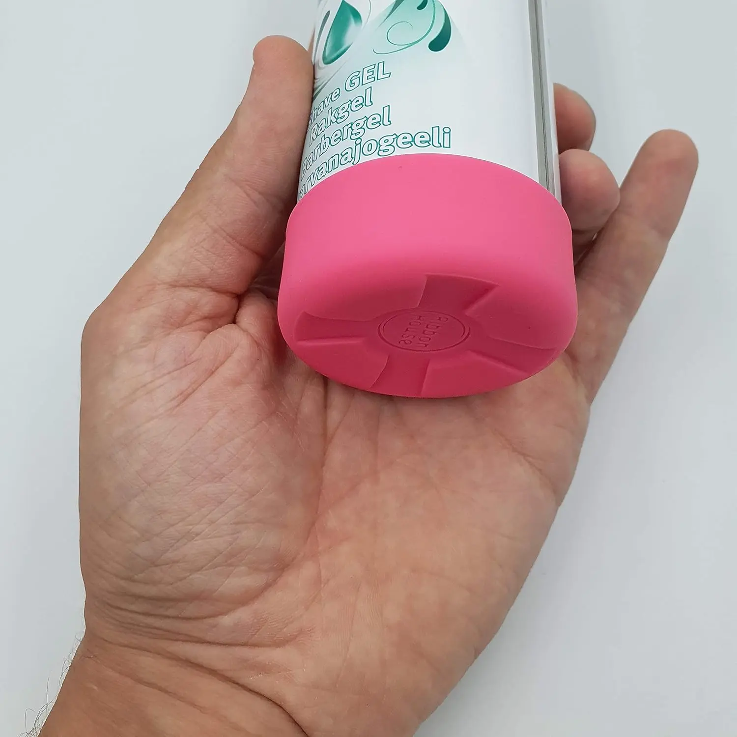 Pink silicone shaving cream can cover prevents rust rings and protects bathroom surfaces from stains and damage.