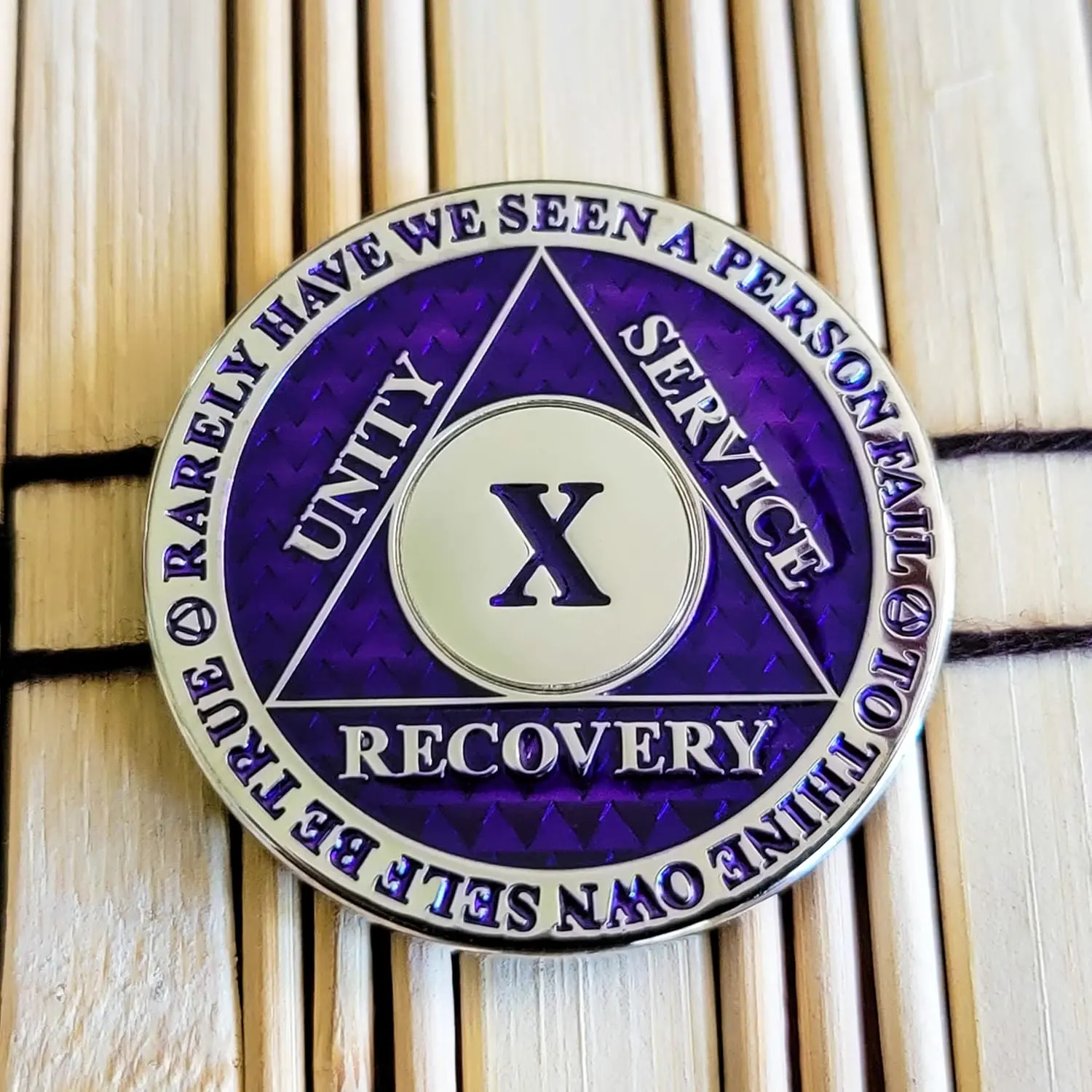 This purple and gold 10 year AA sobriety chip features the three legacies, Serenity Prayer, Chapter 5 of "How it Works," and "To Thine Own Self be True."