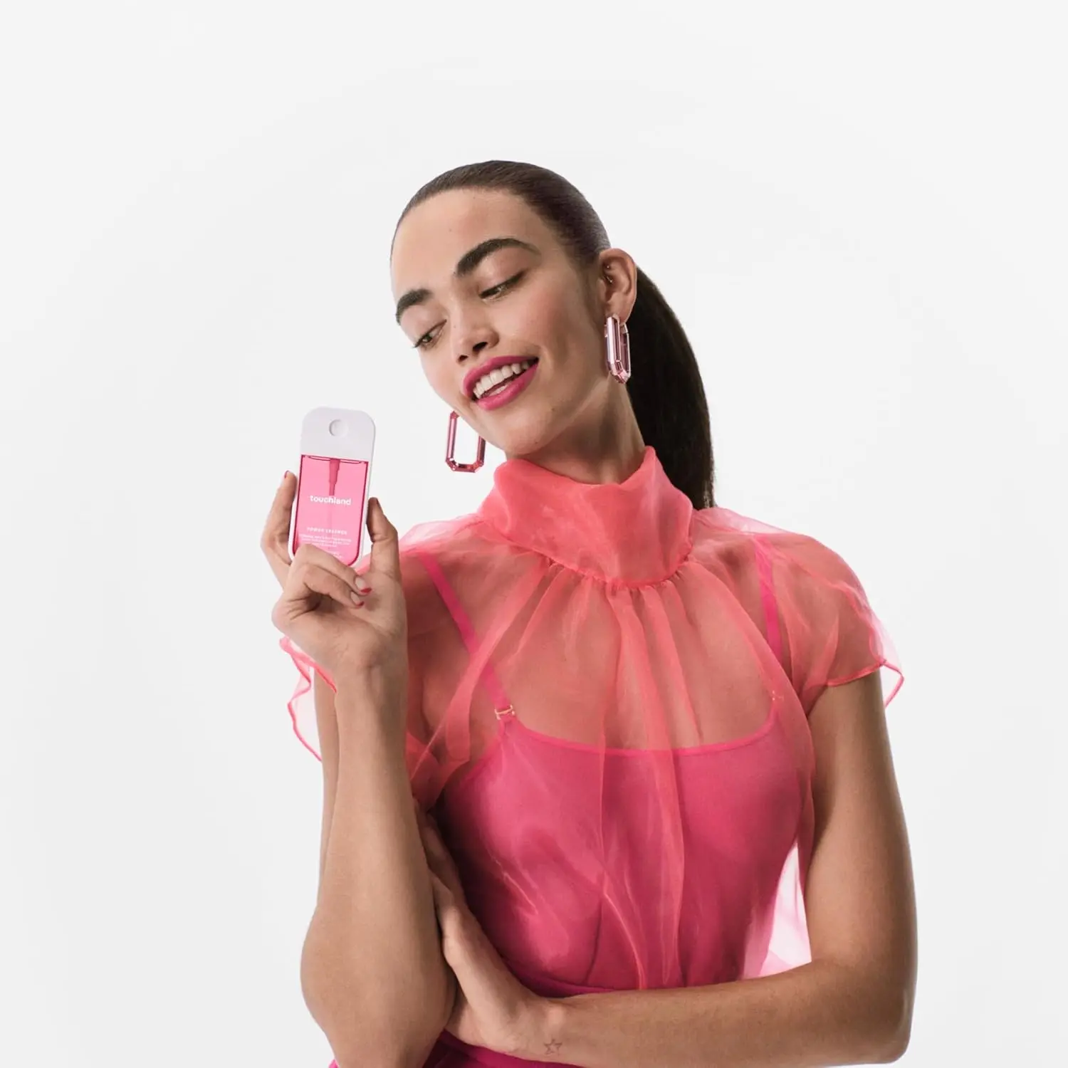 Touchland Lush Tropicale body and hair mist in a sleek white and pink bottle, offering a refreshing tropical scent and hydration.