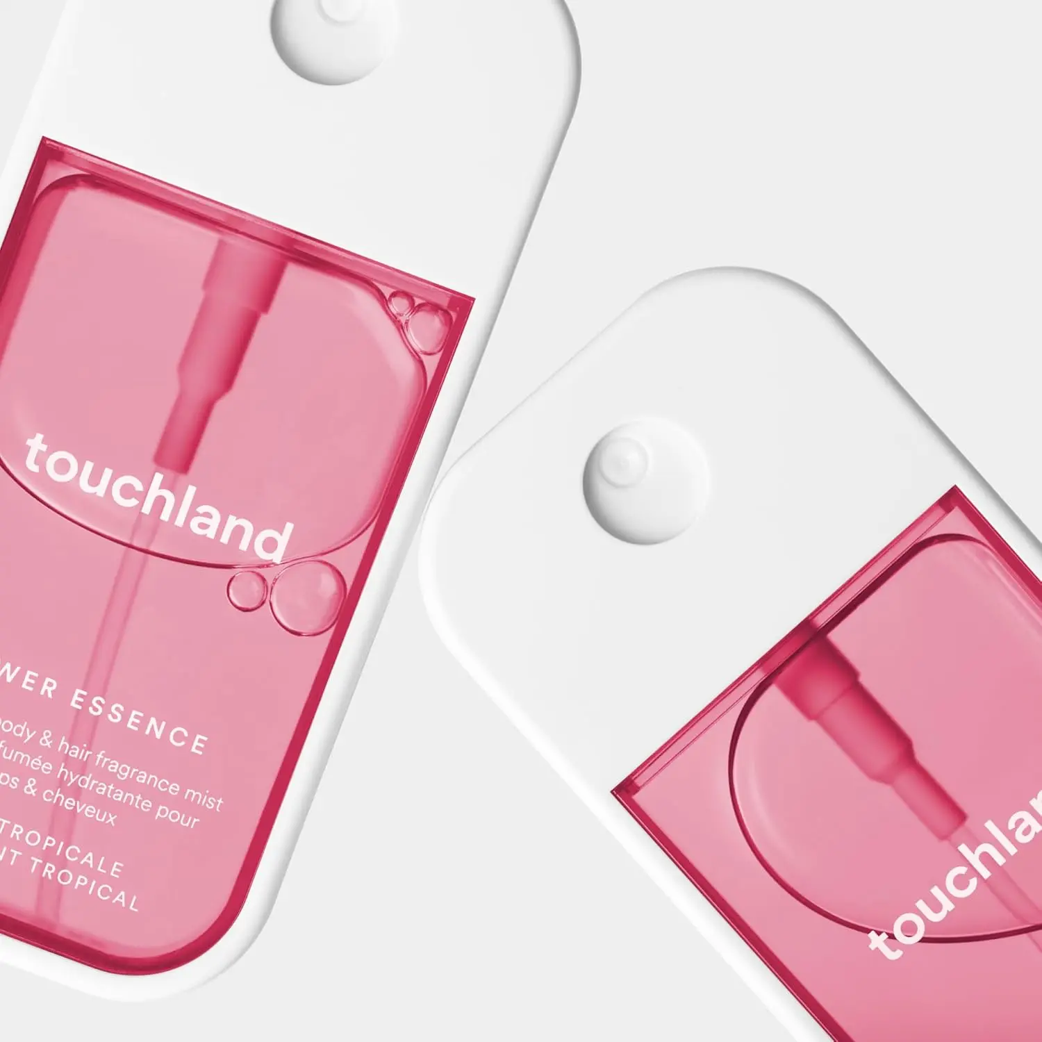 Touchland Lush Tropicale body and hair mist in a sleek white and pink bottle, offering a refreshing tropical scent and hydration.