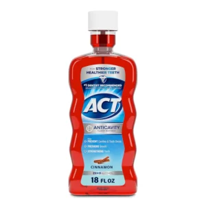ACT Anticavity Zero Alcohol Fluoride Mouthwash in Cinnamon flavor, offering cavity prevention, teeth strengthening, and fresh breath with an accurate dosing cup.