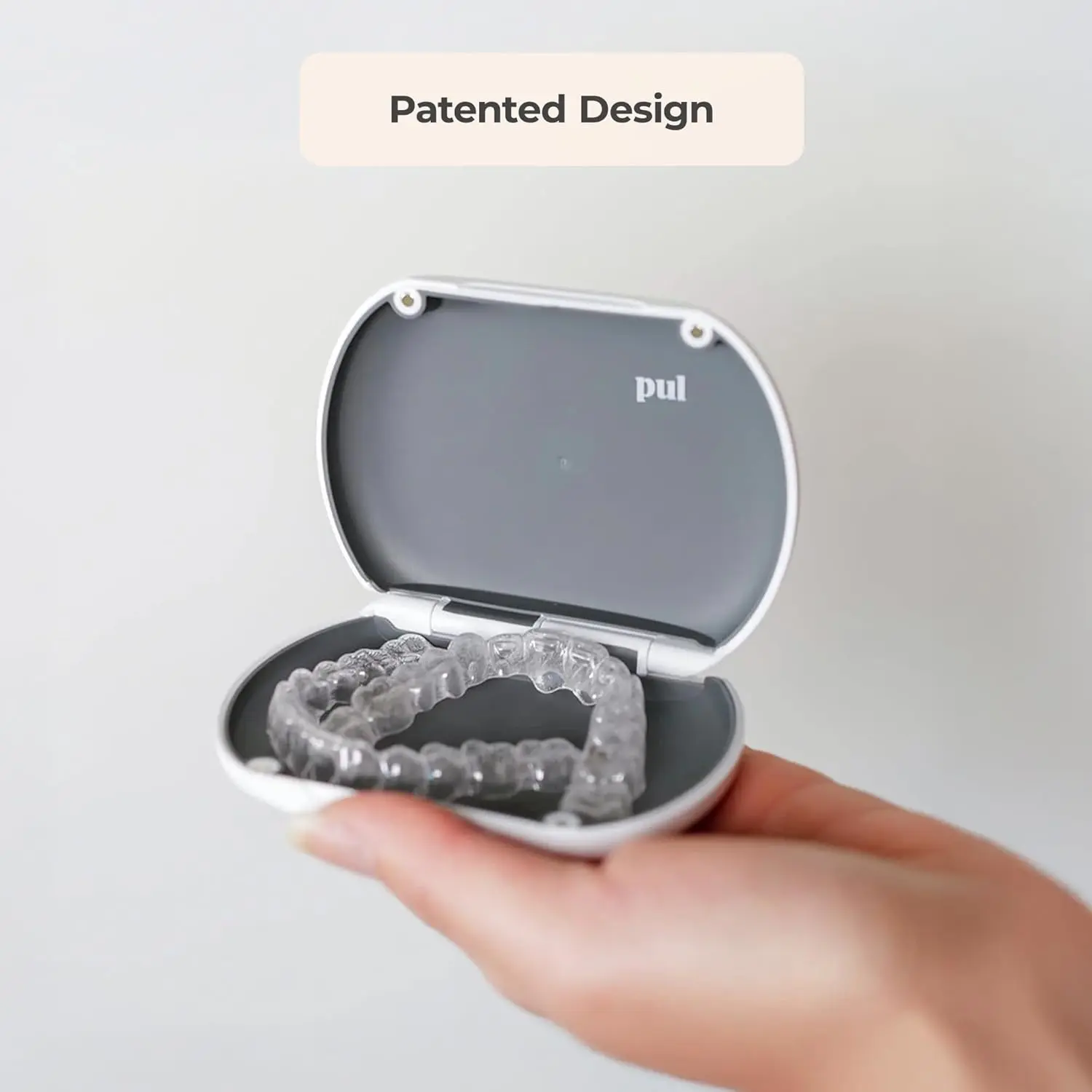 Gray slim and sleek PUL aligner case securely holding clear aligners.