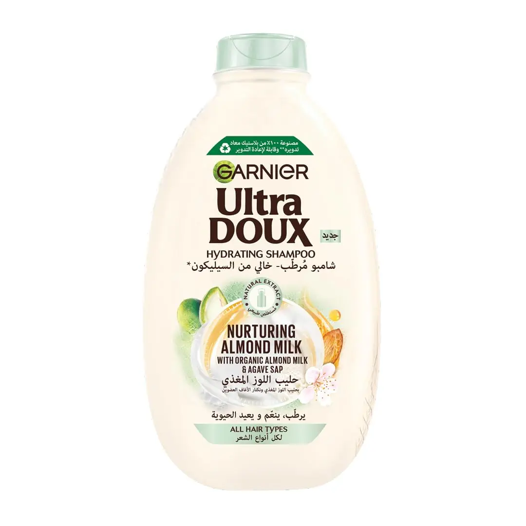 Garnier Ultra Doux almond milk shampoo and conditioner set, designed to hydrate and nurture all hair types without weighing them down, formulated with organic ingredients.