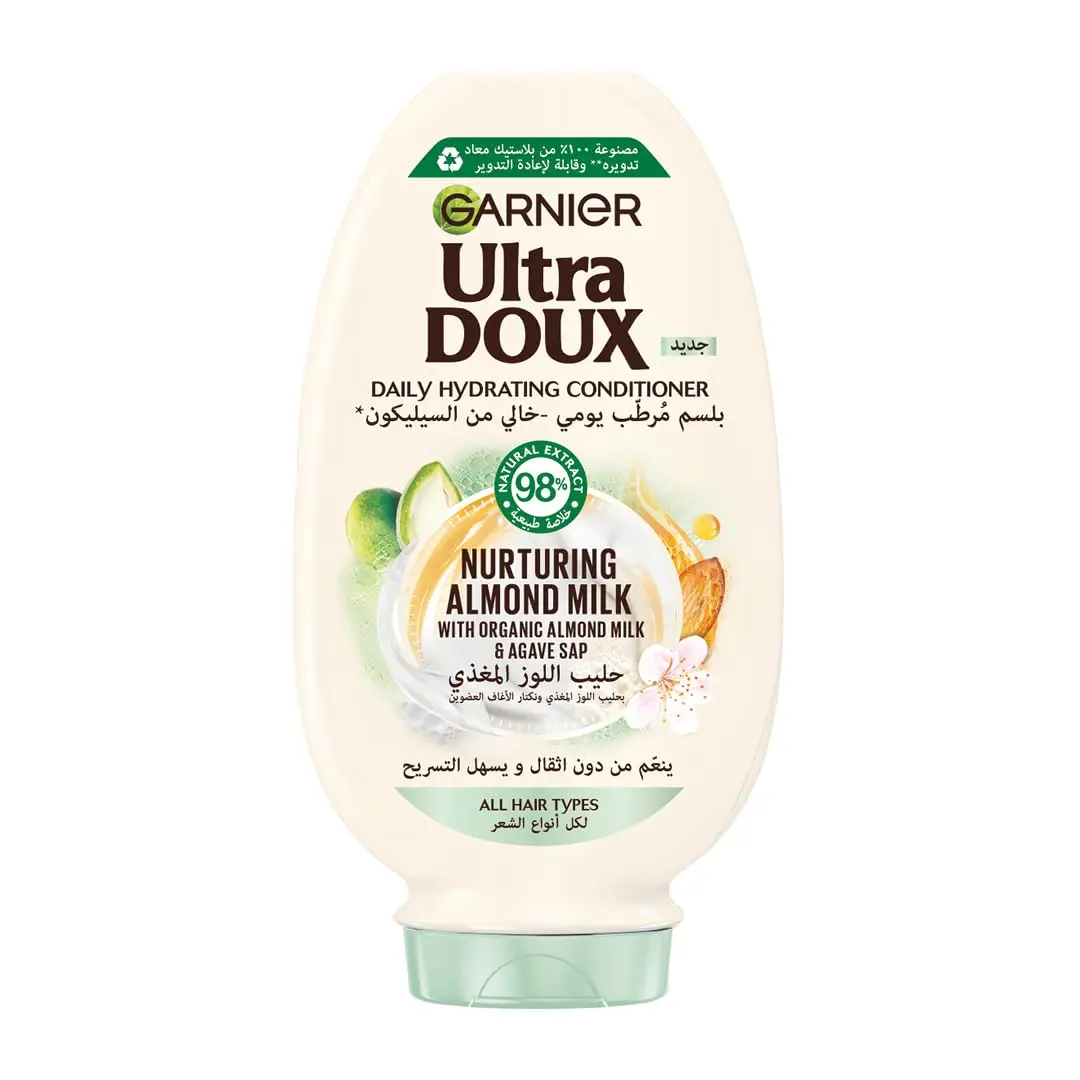 Garnier Ultra Doux almond milk shampoo and conditioner set, designed to hydrate and nurture all hair types without weighing them down, formulated with organic ingredients.