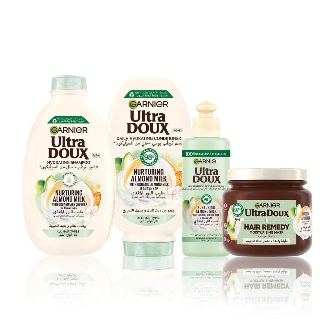 Garnier Ultra Doux almond milk shampoo and conditioner set, designed to hydrate and nurture all hair types without weighing them down, formulated with organic ingredients.