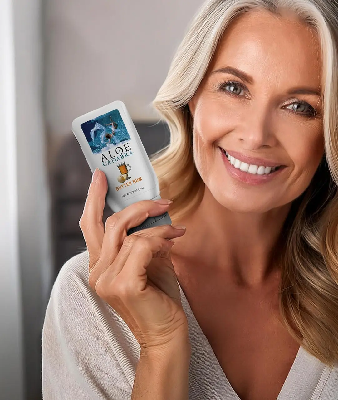 This image shows a 2.5oz bottle of Aloe Cadabra natural butter rum flavored lubricant in hygienic packaging, carefully formulated for women, men, and couples.