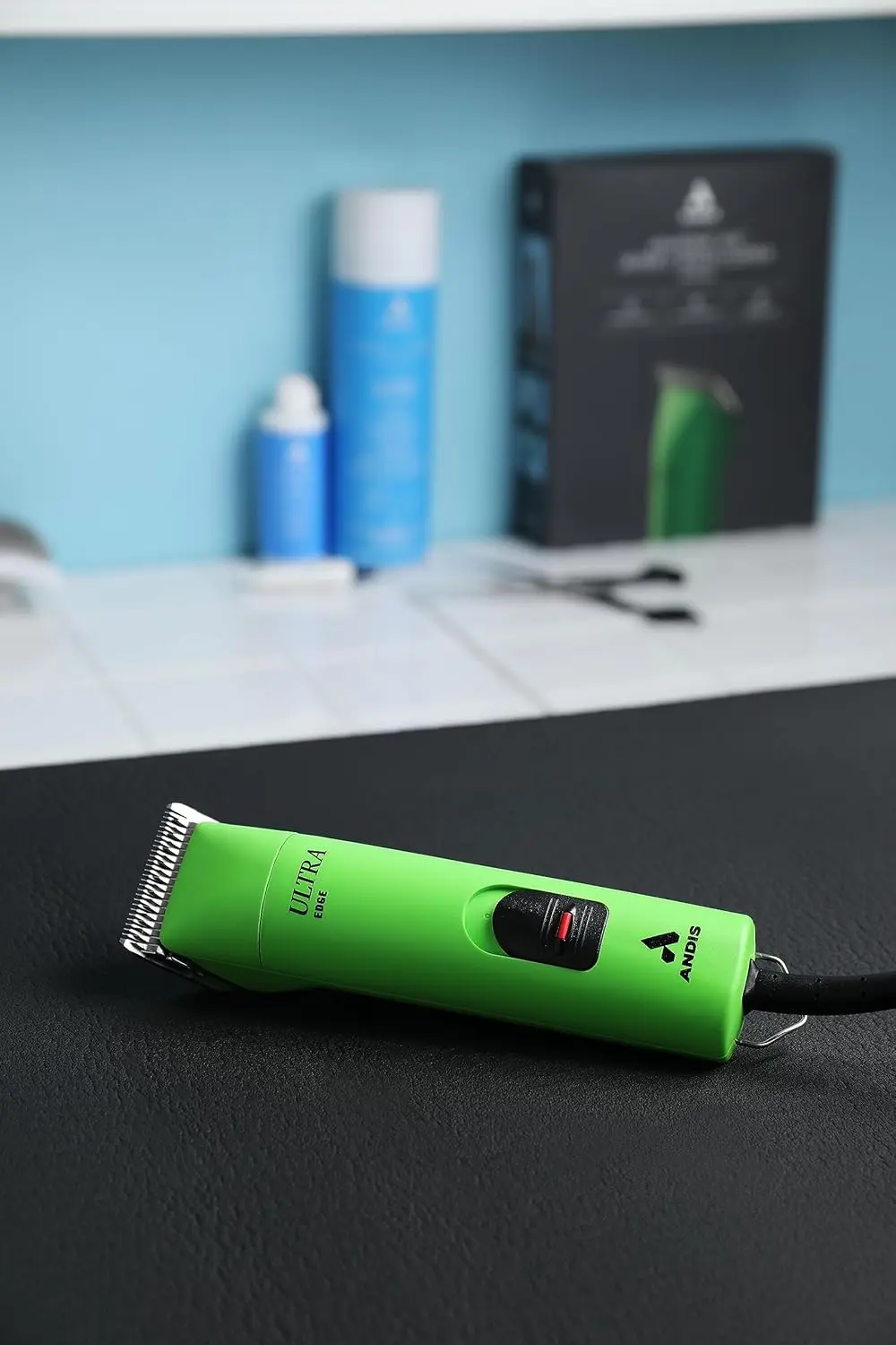 The Andis UltraEdge Super 2-Speed clipper in spring green quickly and quietly trims thick dog hair with its sharp, detachable blade.