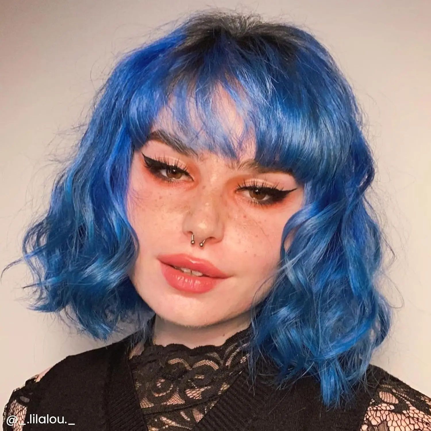 A bottle of Arctic Fox Poseidon blue hair dye, a vibrant, medium true blue vegan and cruelty-free semi-permanent hair color.