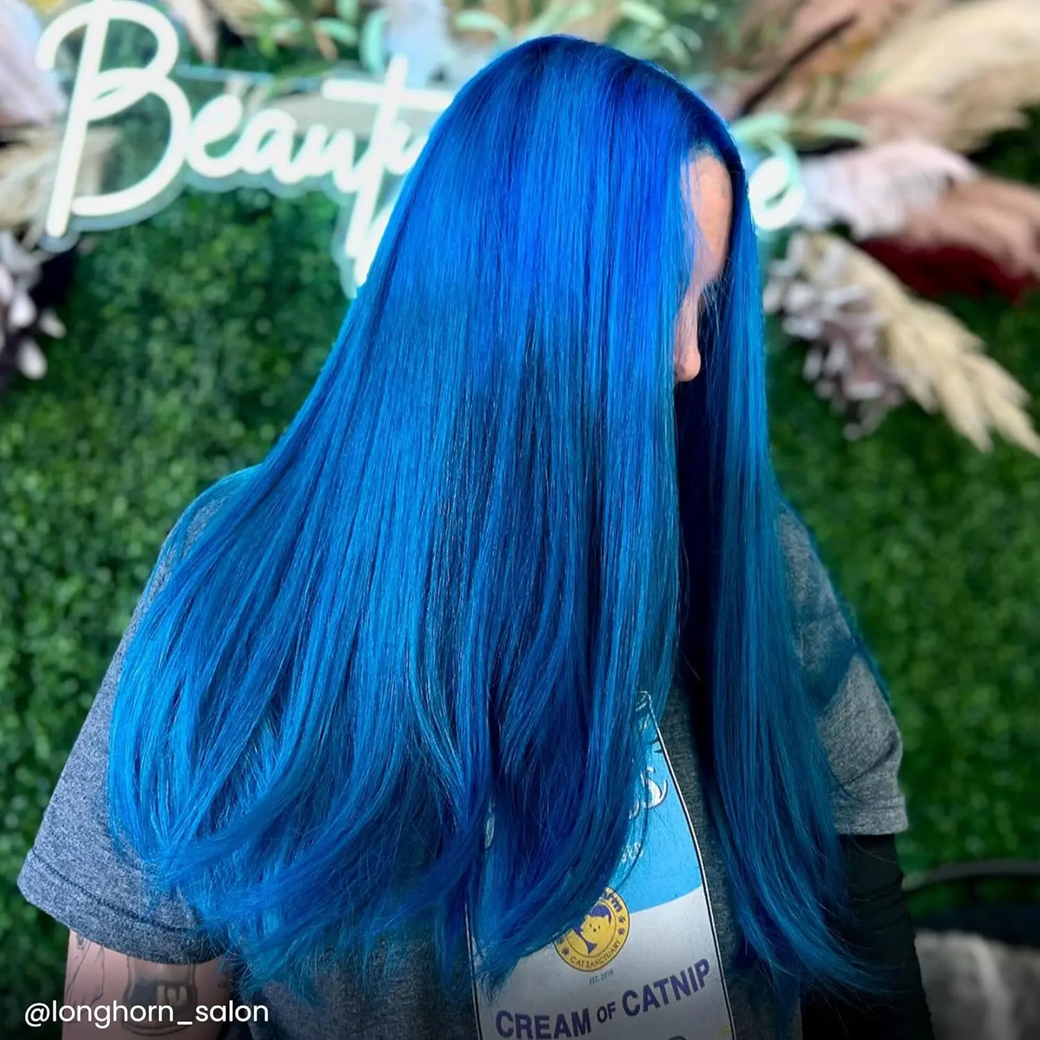 A bottle of Arctic Fox Poseidon blue hair dye, a vibrant, medium true blue vegan and cruelty-free semi-permanent hair color.