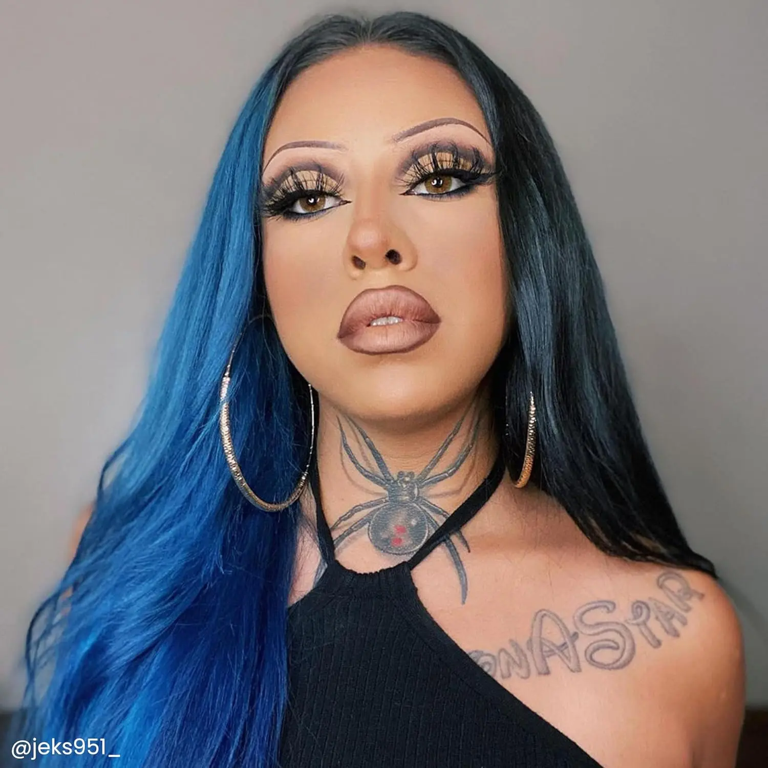 A bottle of Arctic Fox Poseidon blue hair dye, a vibrant, medium true blue vegan and cruelty-free semi-permanent hair color.