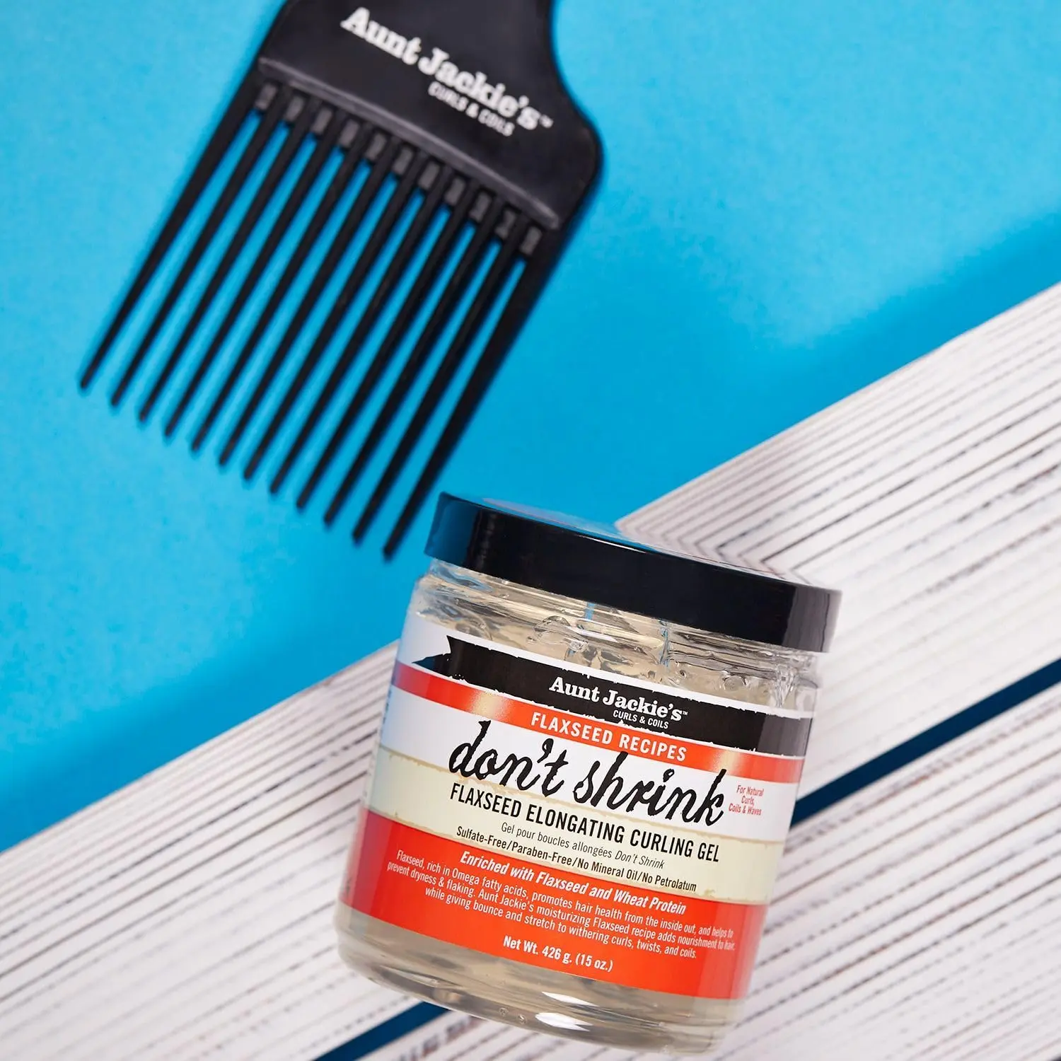 A 15oz jar of Aunt Jackie's Don't Shrink Curling Gel, formulated with omega fatty acids to stretch shriveling curls, improve hair health, and is free of sulfates, parabens, mineral oil, and petrolatum.