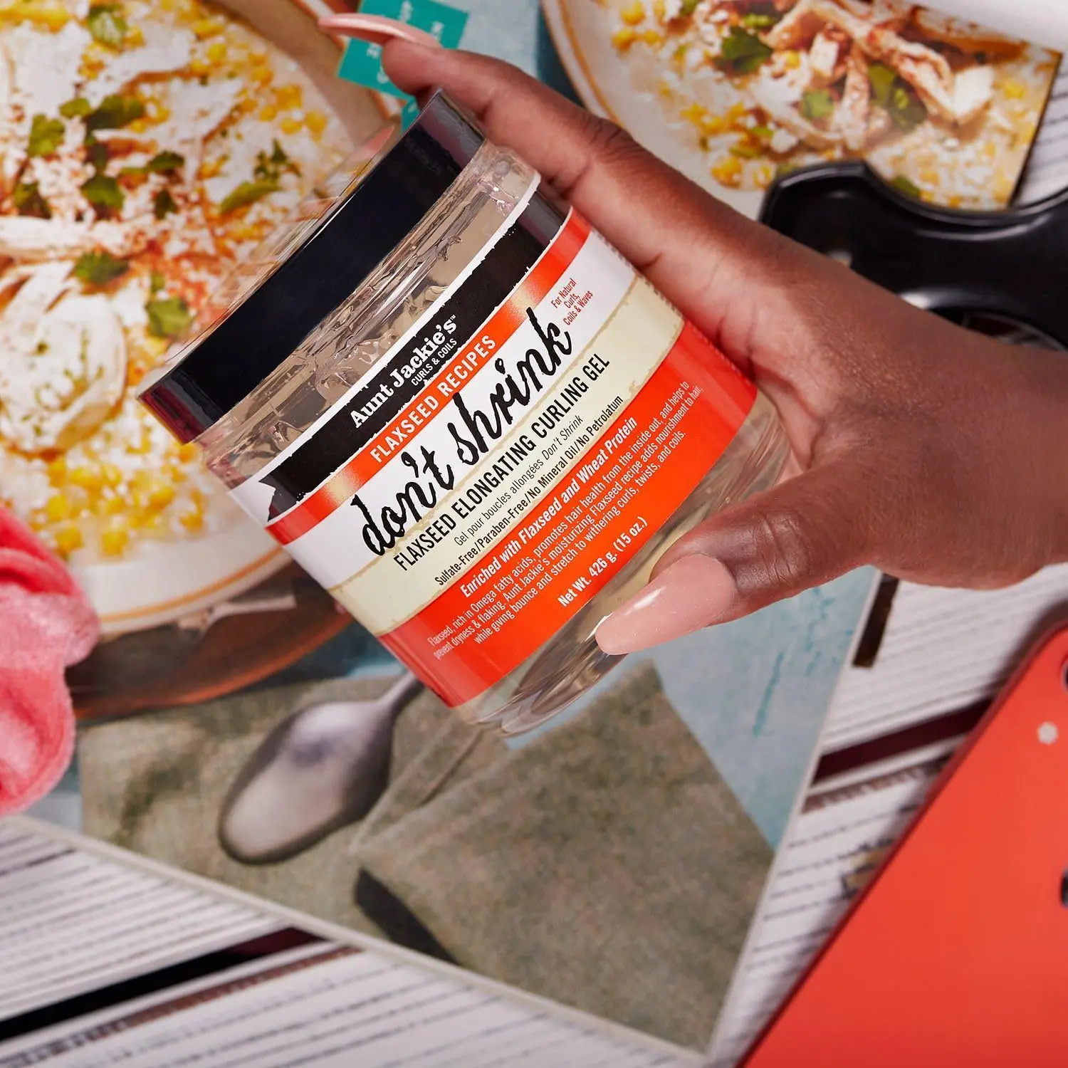 A 15oz jar of Aunt Jackie's Don't Shrink Curling Gel, formulated with omega fatty acids to stretch shriveling curls, improve hair health, and is free of sulfates, parabens, mineral oil, and petrolatum.