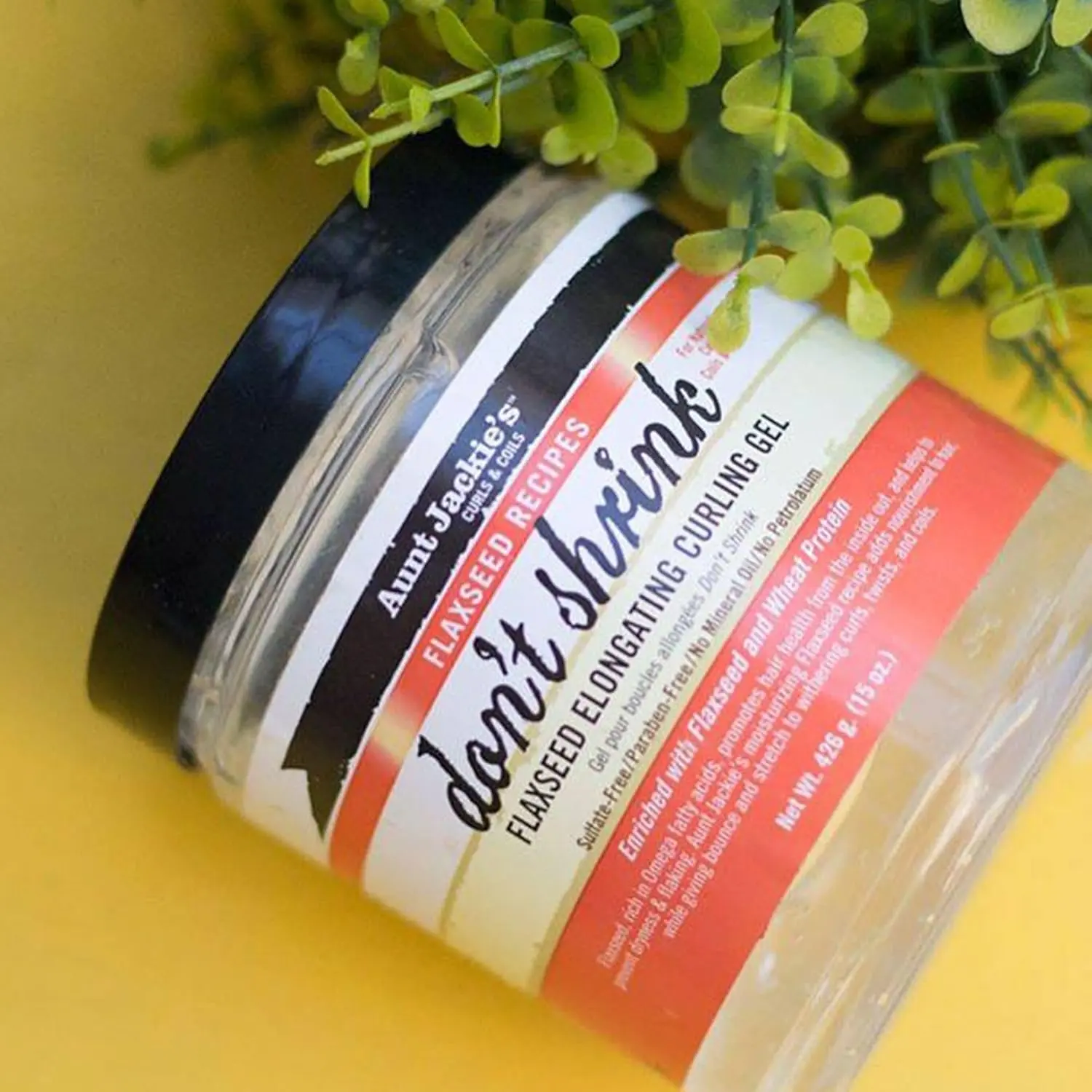 A 15oz jar of Aunt Jackie's Don't Shrink Curling Gel, formulated with omega fatty acids to stretch shriveling curls, improve hair health, and is free of sulfates, parabens, mineral oil, and petrolatum.