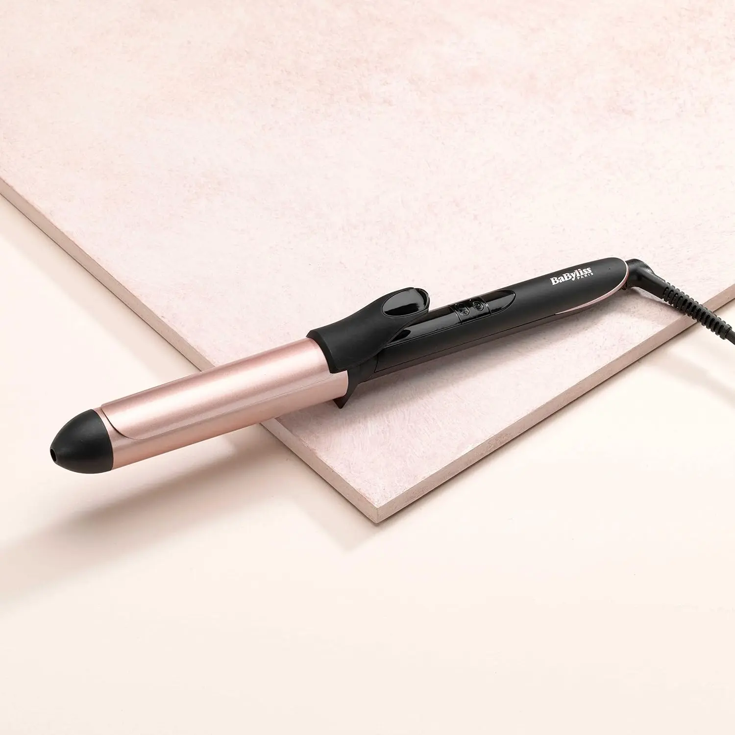The BaByliss rose quartz curling iron has a wide 32mm barrel and digital temperature controls for creating versatile curls on all hair types.