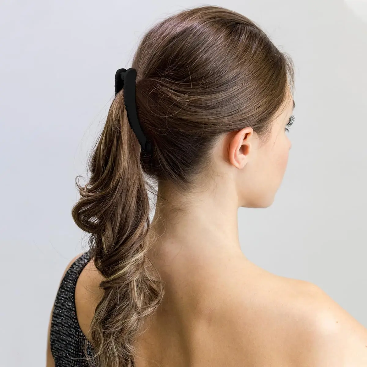 Six banana hair clips in assorted colors and curved styles for creating 80s and 90s-inspired hairstyles, offering a strong hold for ponytails and buns.