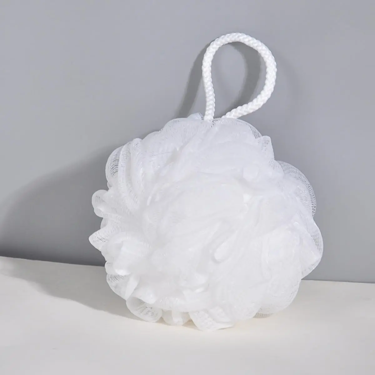 This image shows a four-pack of large, colorful bath loofahs designed for gentle exfoliation and creating a rich lather for a soothing and thorough body cleaning experience.